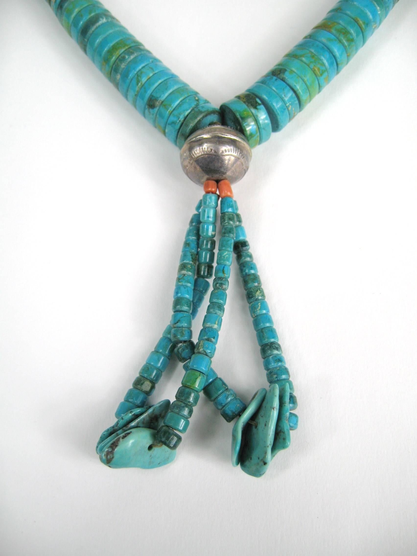 Santo Domingo Pueblo Heishe Turquoise Shell Coral Necklace Jacla Sterling Silver with graduated turquoise heishi necklace with large .73 x .62 inch sterling silver bead and attached jacla. Has sterling silver findings and coral beads at the