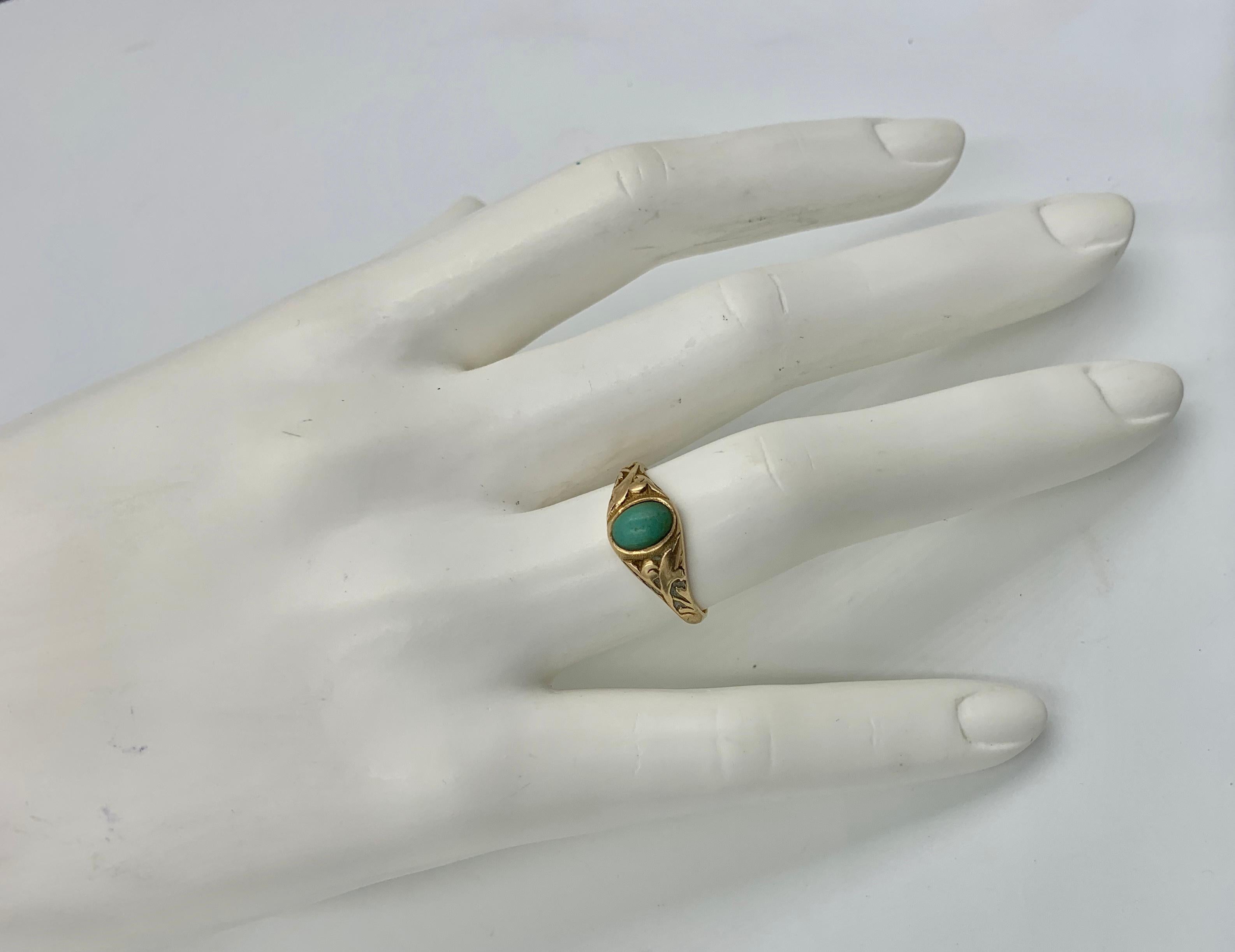 A gorgeous Antique Victorian Turquoise Ring with a gorgeous scroll and leaf motif setting in 14 Karat Rose Gold.  The ring dates to the Victorian period, circa 1850-1890.  It has a stunning oval Turquoise cabochon surrounded by acanthus leaf motif