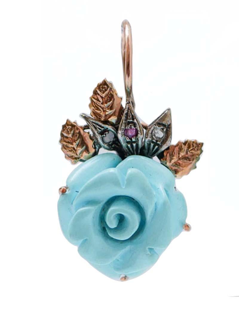 Dangle earrings in 9 kt rose gold and silver structure mounted with leaves studded with diamonds and rubies and, as pendant, a flower of turquoise paste.
These earrings were totally handmade by Italian master goldsmiths and they are in perfect