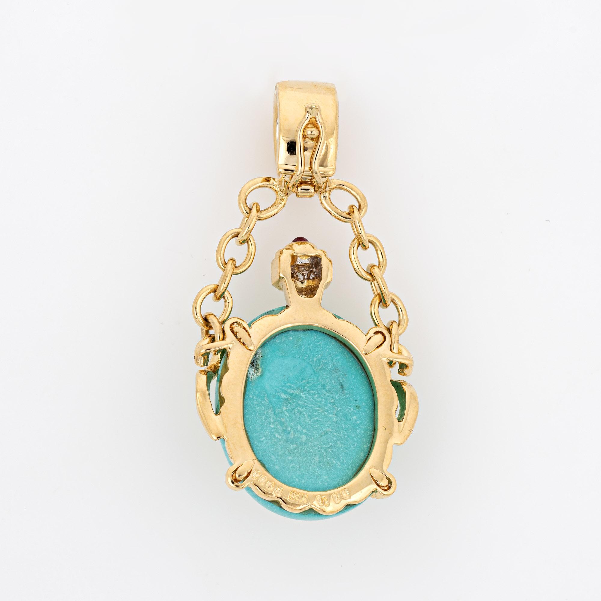 Finely detailed turquoise, ruby & diamond bottle pendant crafted in 18k yellow gold.  

Diamonds total an estimated 0.10 carats (estimated at H-I color and SI1-I1 clarity). Cabochon cut rubies total an estimated 0.33 carats. Turquoise measures 19mm