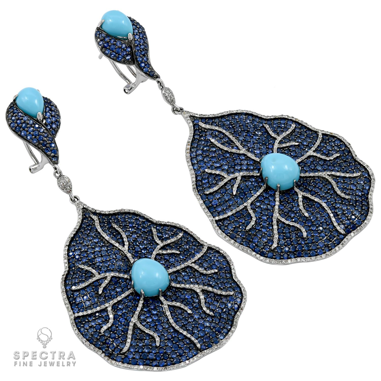 Beautiful and festive chandelier earrings, comprising of cabochon turquoise stones, sapphires and diamonds.
All stones are natural.
Metal is 18k white gold; gross weight: 32.94 g.
3.22 in long (8.2 cm).