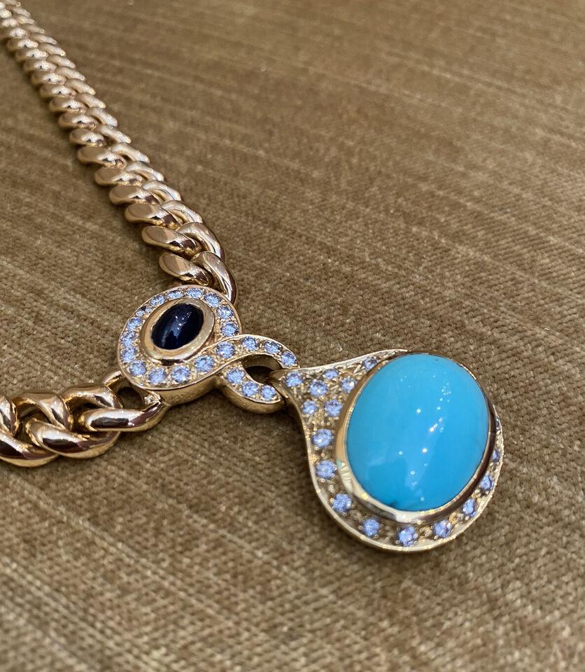 Turquoise, Sapphire & Diamond Necklace on Link Chain in 18k Yellow Gold

Turquoise, Sapphire & Diamond Necklace features a large 19.3 x 14.3 mm Oval shaped Turquoise, a Sapphire cabochon, and  1.50 carats of Round Brilliant Diamonds on a beautiful