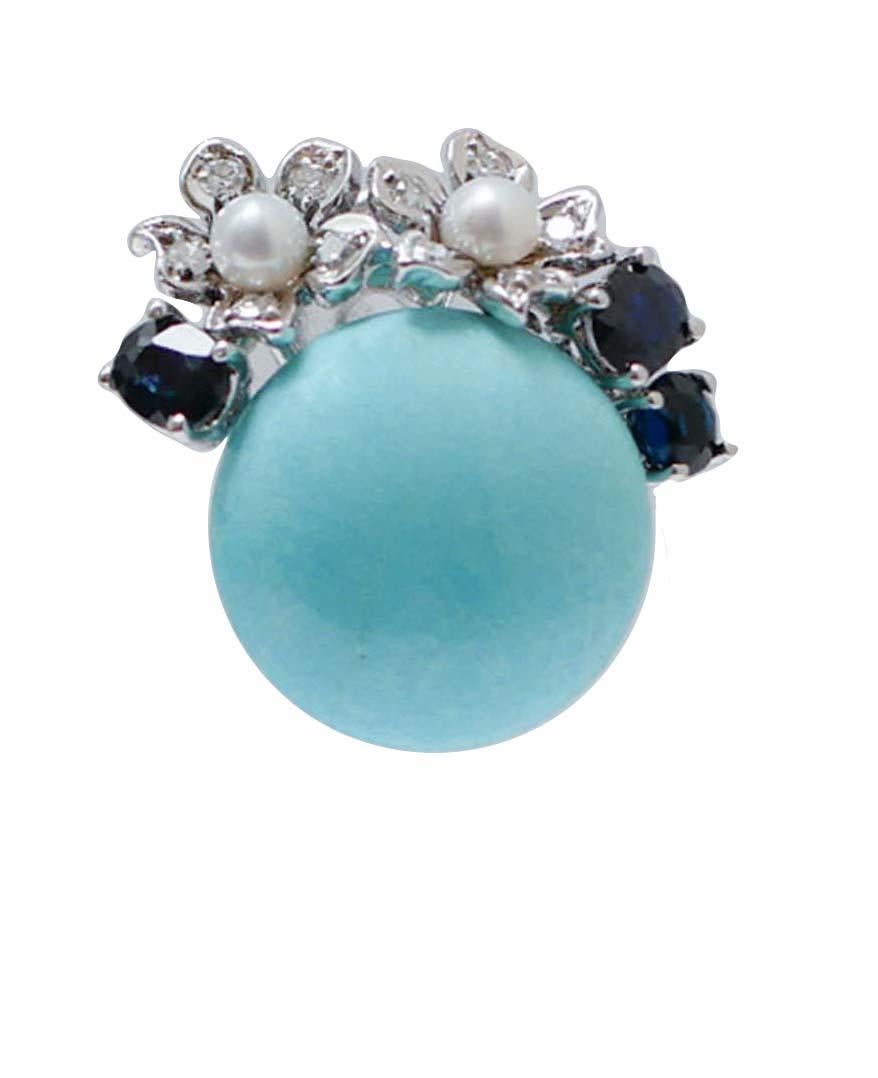 Amazing earrings in 14 kt white gold structure mounted with a central turquoise  and, on it, leaves studded with diamonds, sapphires and pearls.
These earrings were totally handmade by Italian master goldsmiths and they are in perfect