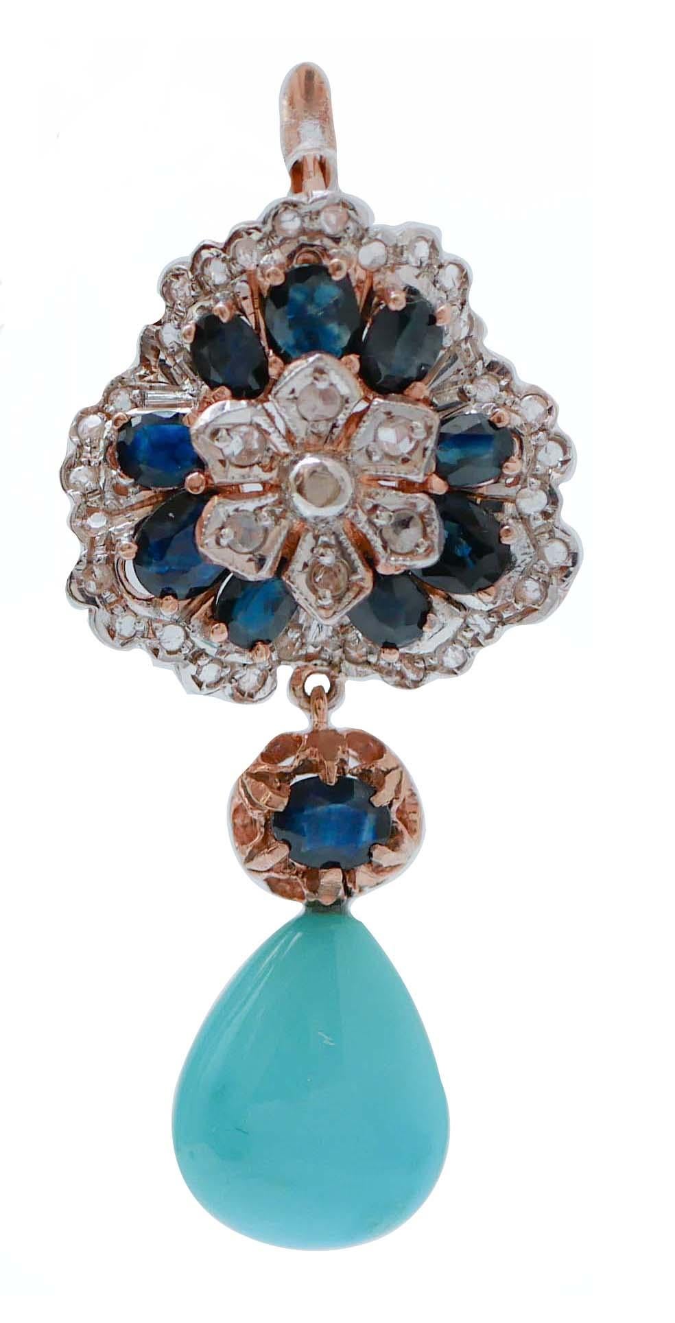 Fantastic earrings in 9 kt rose gold and silver structure mounted with a flower of diamonds surrounded by sapphires and diamonds in the upper part; in the middle, a sapphire and, as pendant, a turquoise.
These earrings were totally handmade by