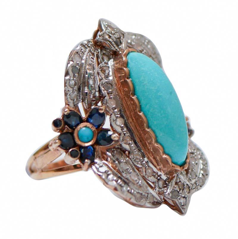 Fantastic ring in 9 kt rose gold and silver structure mounted with a central turquoise surrounded by diamonds and, laterally, a flower of sapphires and a little turquoise.
This ring was totally handmade by Italian master goldsmiths and it is in