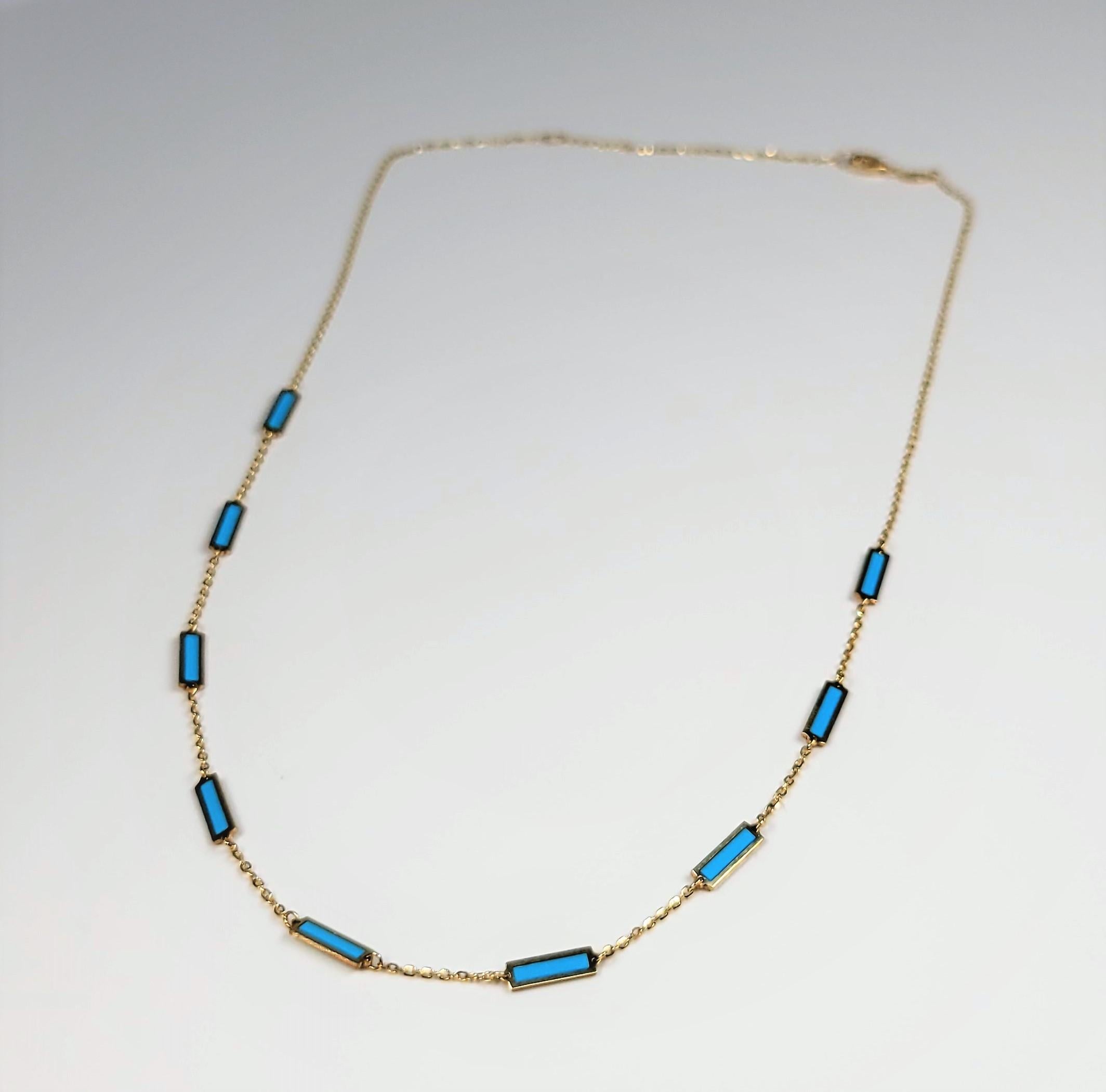 This fun adjustable yellow gold and turquoise station necklace can be worn as  16