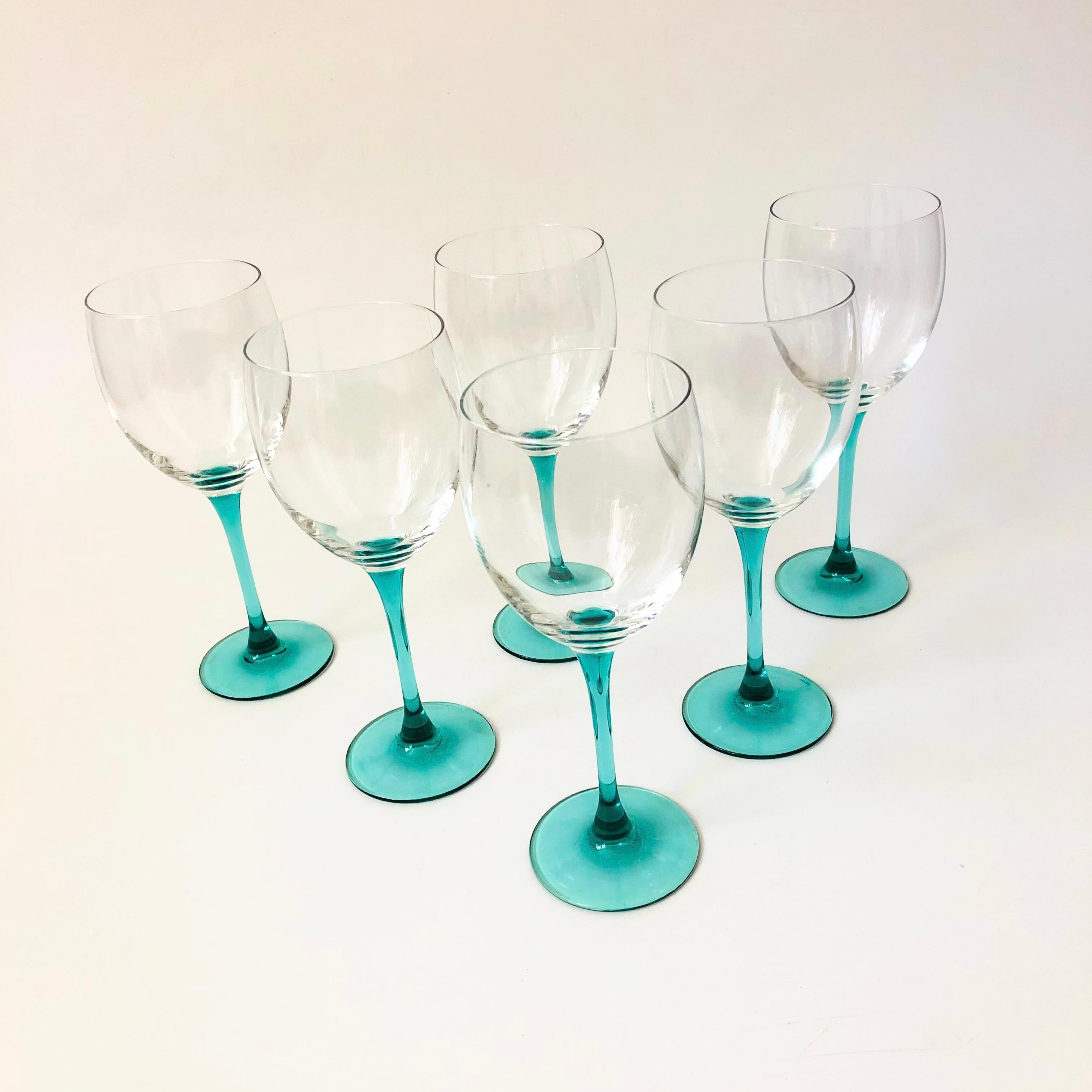 A set of 6 vintage 1980s wine glasses. Each has a lovely turquoise stem and clear top. Made in France by Luminarc, marked on the bases.

