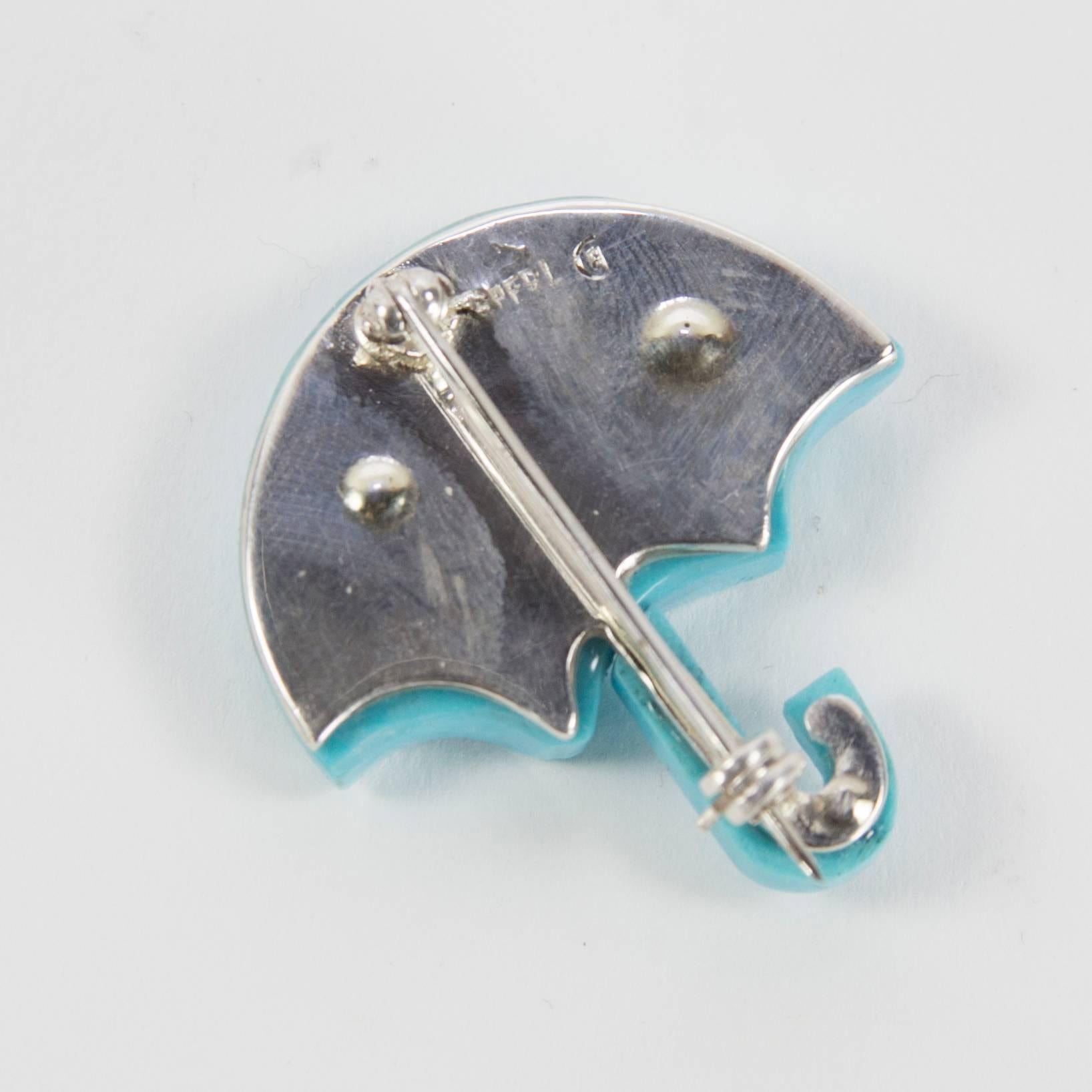 Beautifully Hand crafted reconstituted Turquoise and Sterling Silver brooch in the form of an open umbrella. Marked: STERLING; approx. size: 1.25” x 1.25”; Chic and Unique...Illuminating your Look with Timeless Beauty, rain or shine! 
