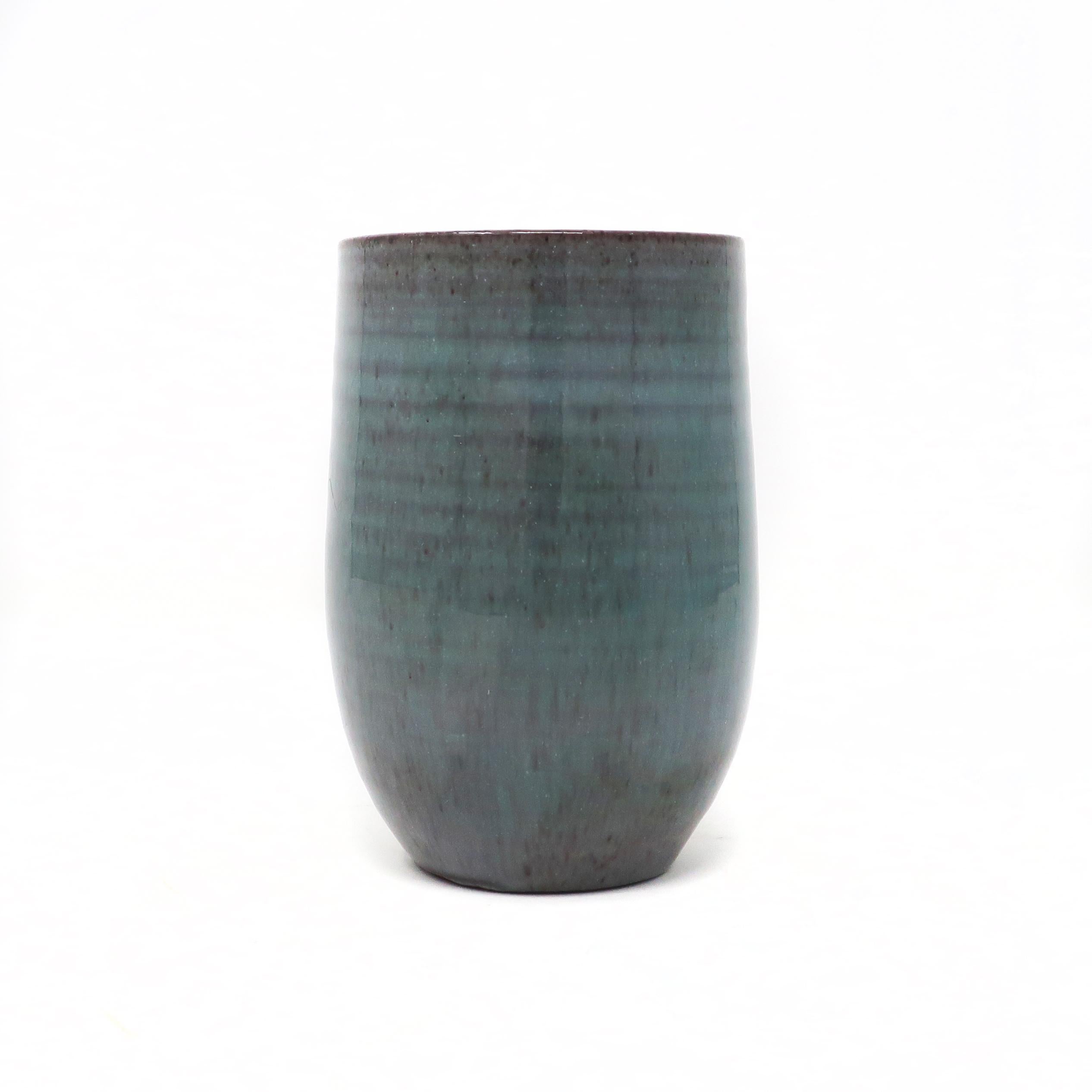A lovely turquoise ceramic cup by Edwin & Mary Scheier, one of the best known couples to ever work in pottery. Edwin (1910-2008) and Mary (1908-2007)began creating together in the 1930s. This piece has a delicate and sophisticated thin wall, tapered