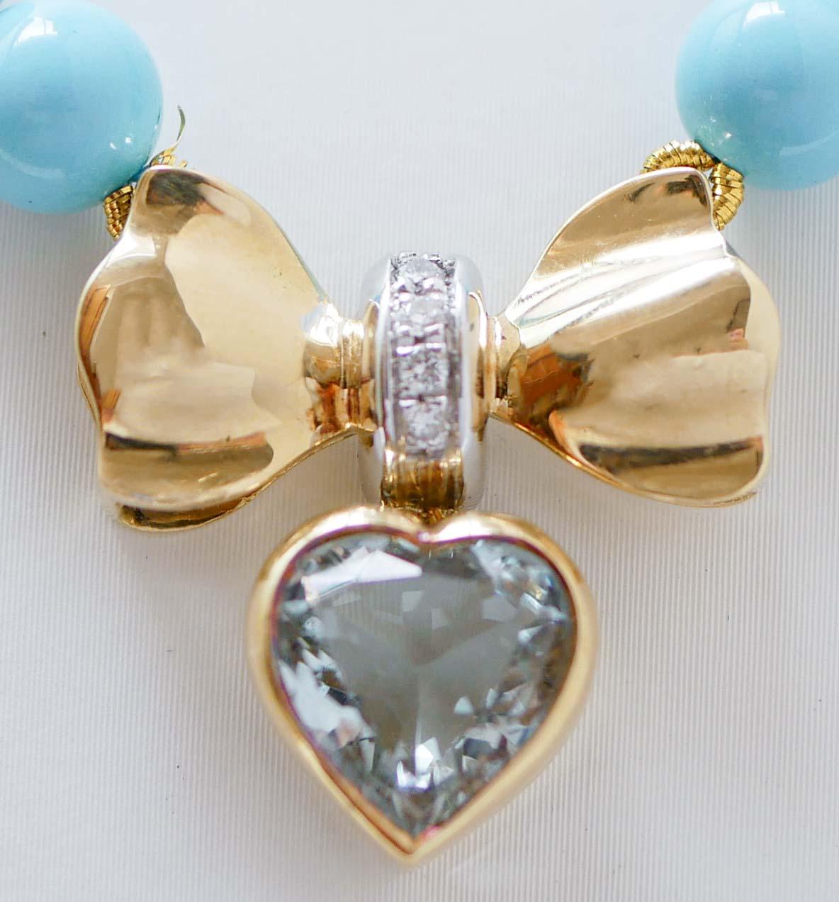 Elegant necklace mounted with a pendant in 18 kt yellow gold structure with a heart topaz and diamonds. Alomg the lenght, spheres of turquoise paste and two gold spheres.
This necklace was totally handmade by Italian master goldsmiths and it is in