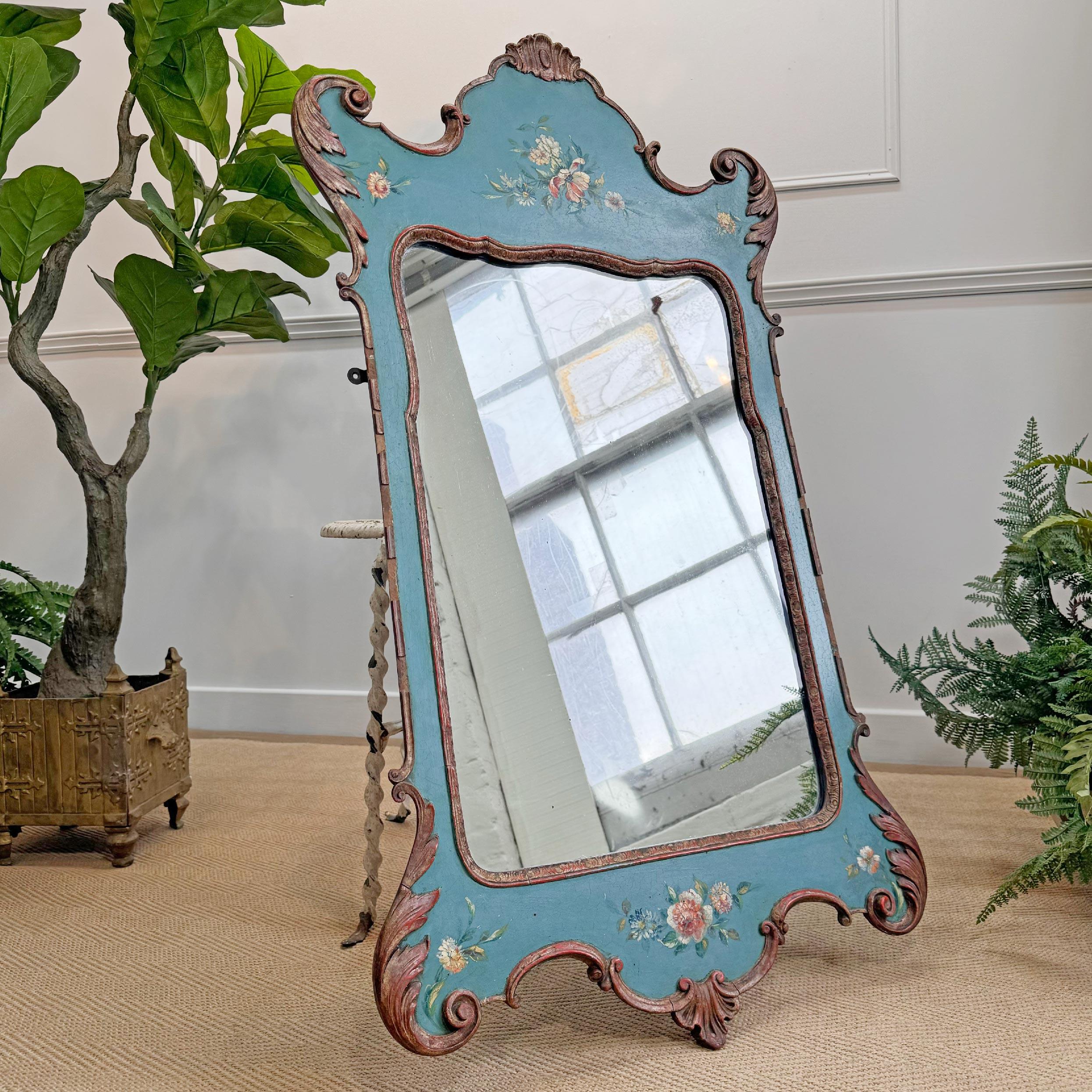 A striking Venetian style mirror, circa 1920. Carved wood with applied gesso decoration and polychrome painted with floral motifs in reds, white, yellow and greens over a bright turquoise background. 

The mirror is a very good size, with the