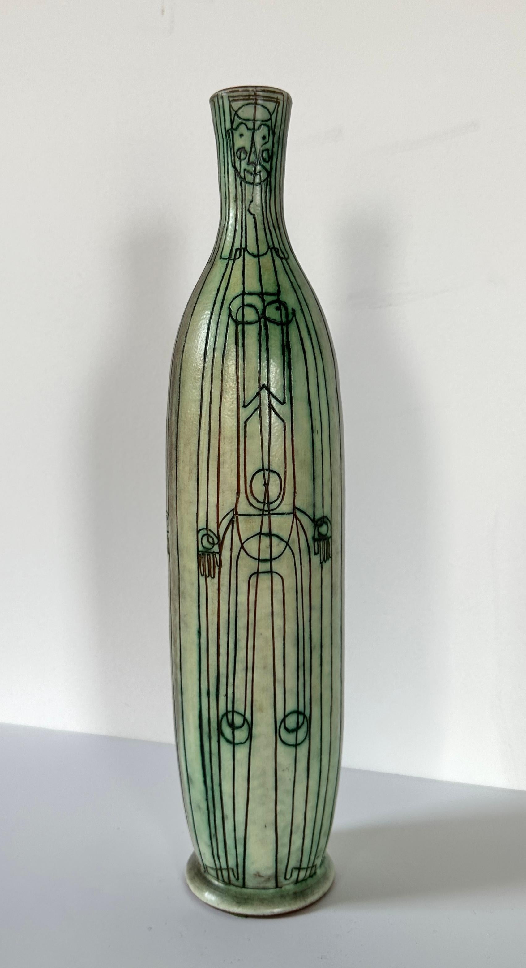 A charming sgraffito vase by Theo and Susan Halander of Ontario, Canada. Three figures inscribed onto this verdigris-like glazed surface give it a lively storytelling aesthetic. Mid-20th century.