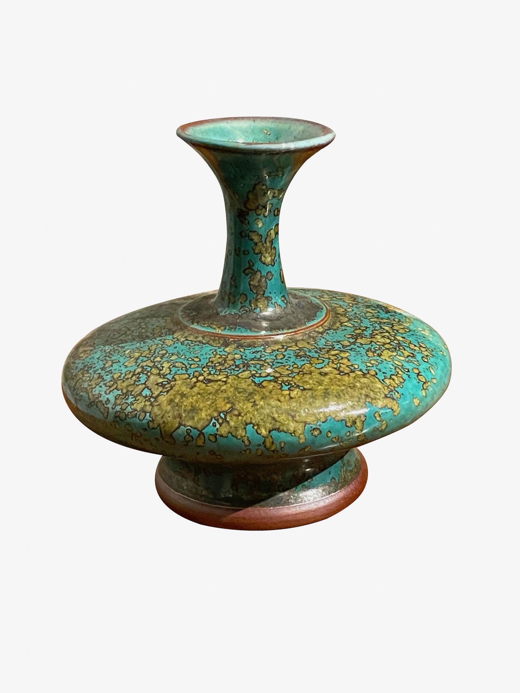 Contemporary Chinese turquoise with gold speckled glaze vase.
Flat shaped base with tall thin neck with wide spout opening.
One of several pieces from a large collection.