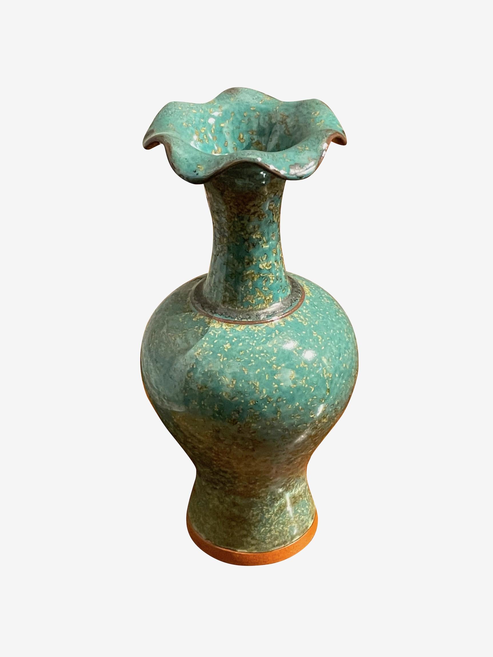 Contemporary Chinese turquoise with gold speckled glaze vase.
Tall classic shape with decorative scalloped spout opening.
Two are available and sold individually.
One of several pieces from a large collection.
