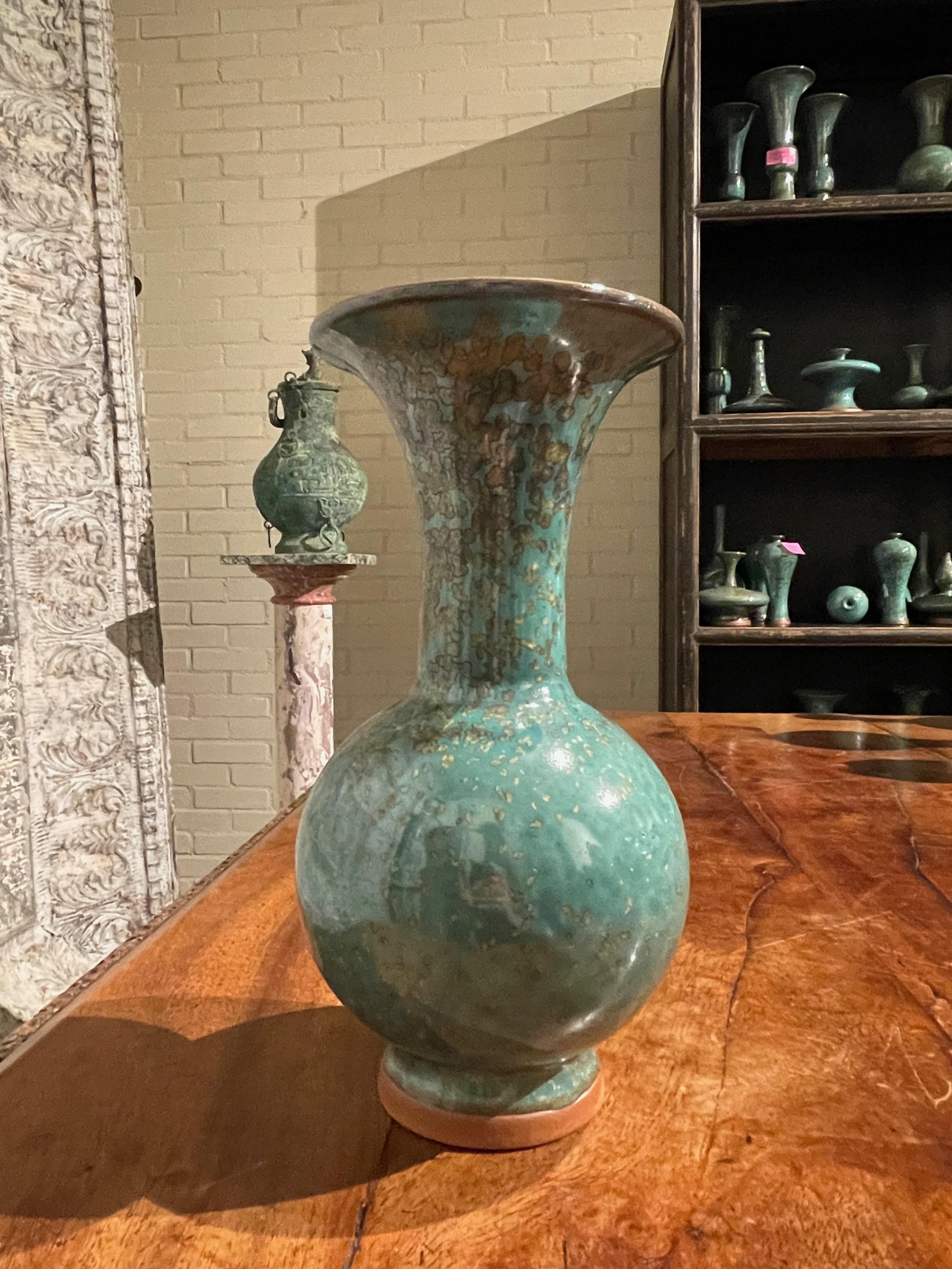 Contemporary Chinese turquoise with gold speckled glaze vase.
Classic shape with wide spout opening.
Two available and sold individually.
One of several pieces from a large collection.