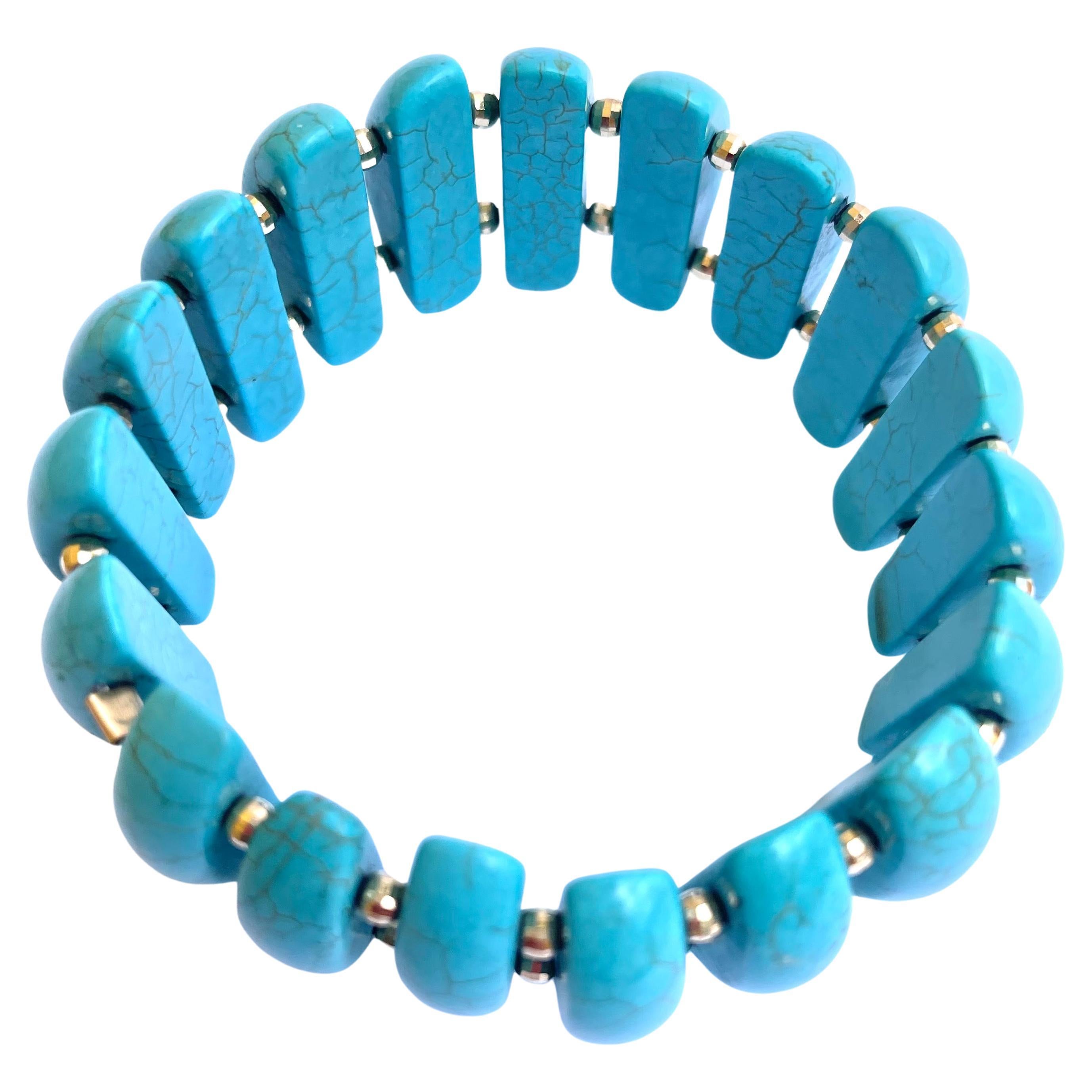 Description
Turquoise half-dome shape with 14k yellow gold faceted balls stretchy bracelet.
Item #B1179

Materials and Weight
Turquoise 252 carats, 8 x 25mm, half-dome shape.
Faceted balls 3mm 14k yellow gold, 36 pieces.

Dimensions
Size 7