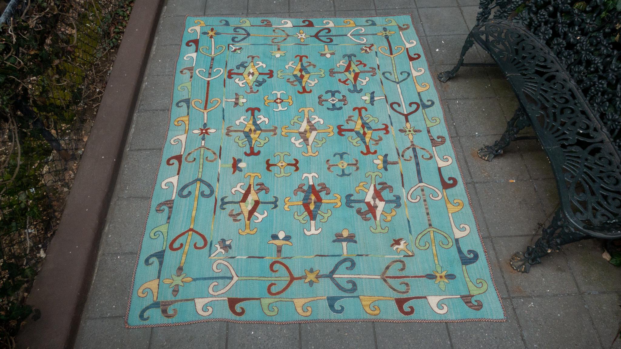 Suzani style turquoise wool rug from Afghanistan.