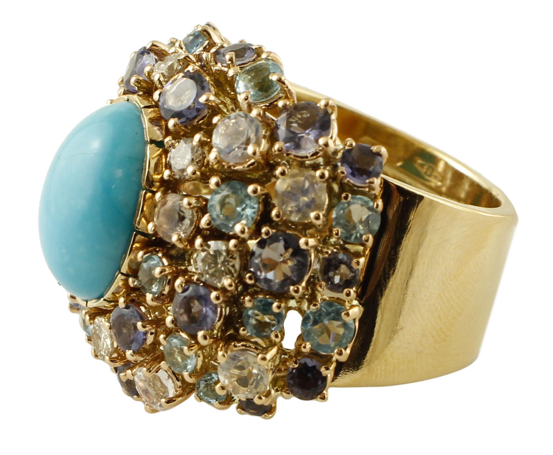 

Beautiful vintage ring in 14 kt yellow gold structure, mounted with a central turquoise (1 x 1.3 cm) surrounded with diamonds, white sapphires, topazes and iolite.
This ring is totally handmade by Italian master goldsmiths.
Diamonds 0.44 ct
White