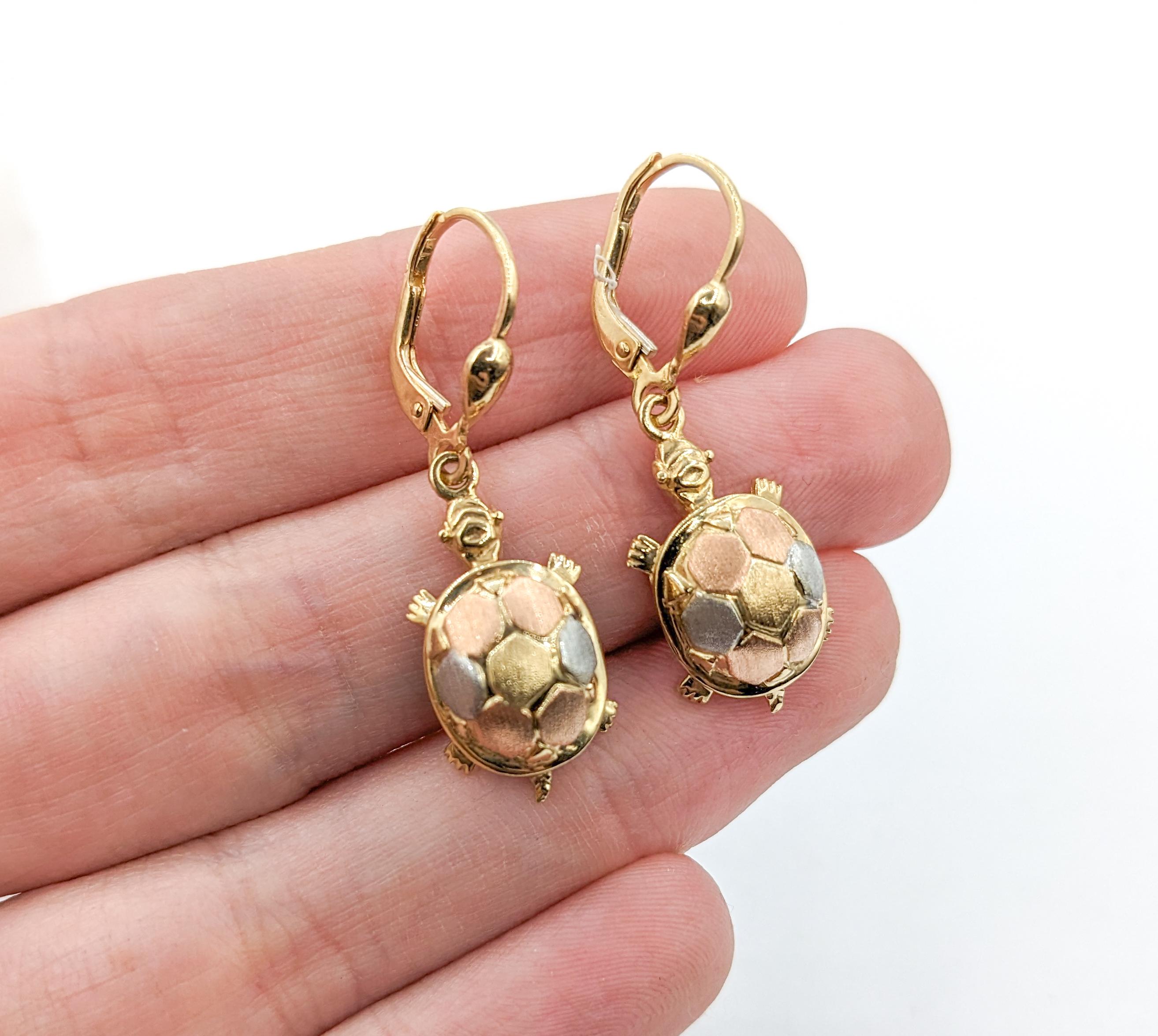 Turtle Dangle Earrings in Tri-Color Gold 

Introducing these exquisite tri-color gold earrings, Turtle dangles crafted in 10kt Tri Color. The Turtle earrings showcase intricate detailing with multi-color shells for added elegance. Sized at