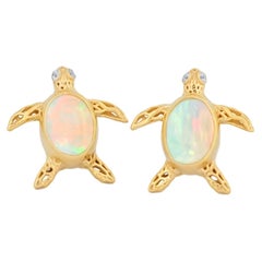 Turtle earrings studs with opals in 14k gold.