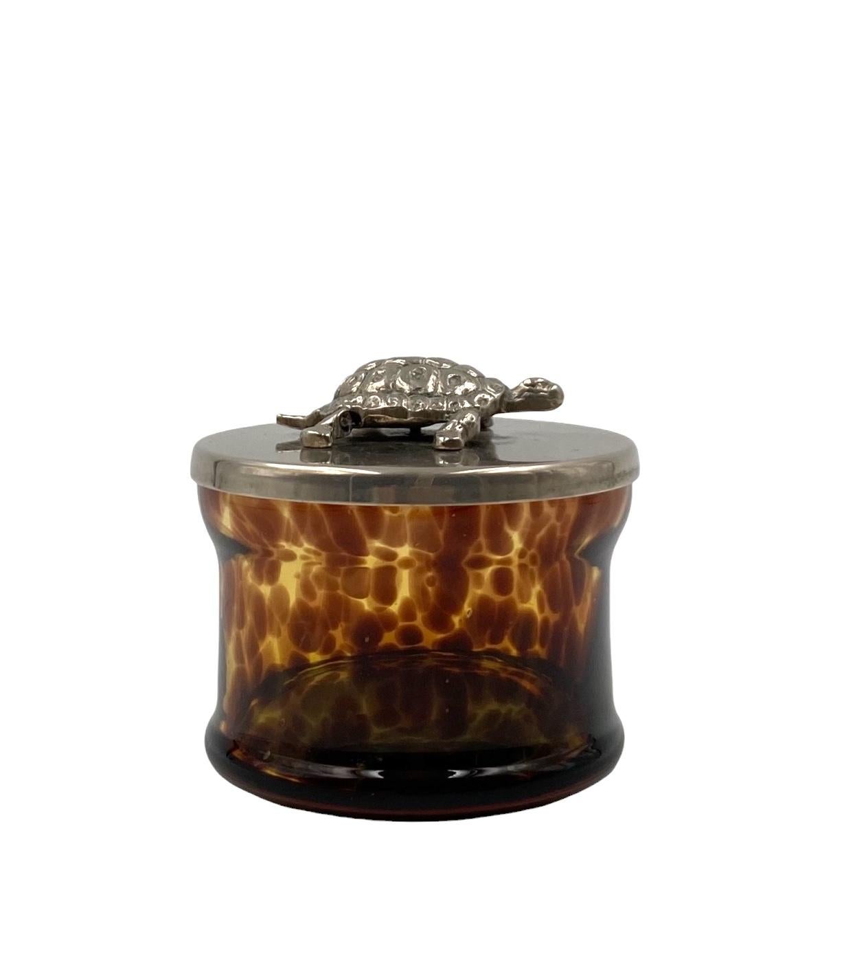 Turtle glass Box

France 1970s

glass, silver-plated cap with turtle

H 9 cm x 12 cm diam.

Conditions: excellent consistent with age and use.