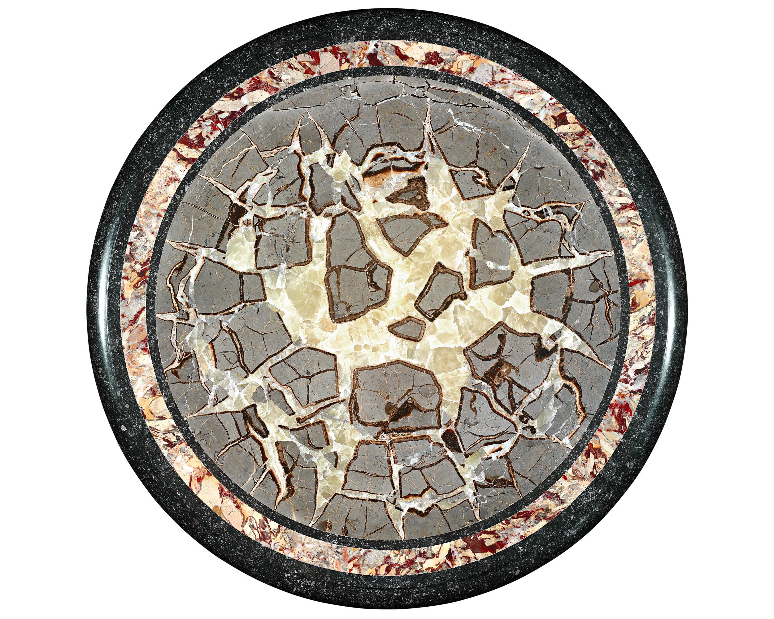 A remarkable display of English craftsmanship and a fascinating relic of natural history, this Regency-style table features an awe-inspiring specimen of turtle stone, an English marble formed from fossilized spheres known as septarian nodules. This