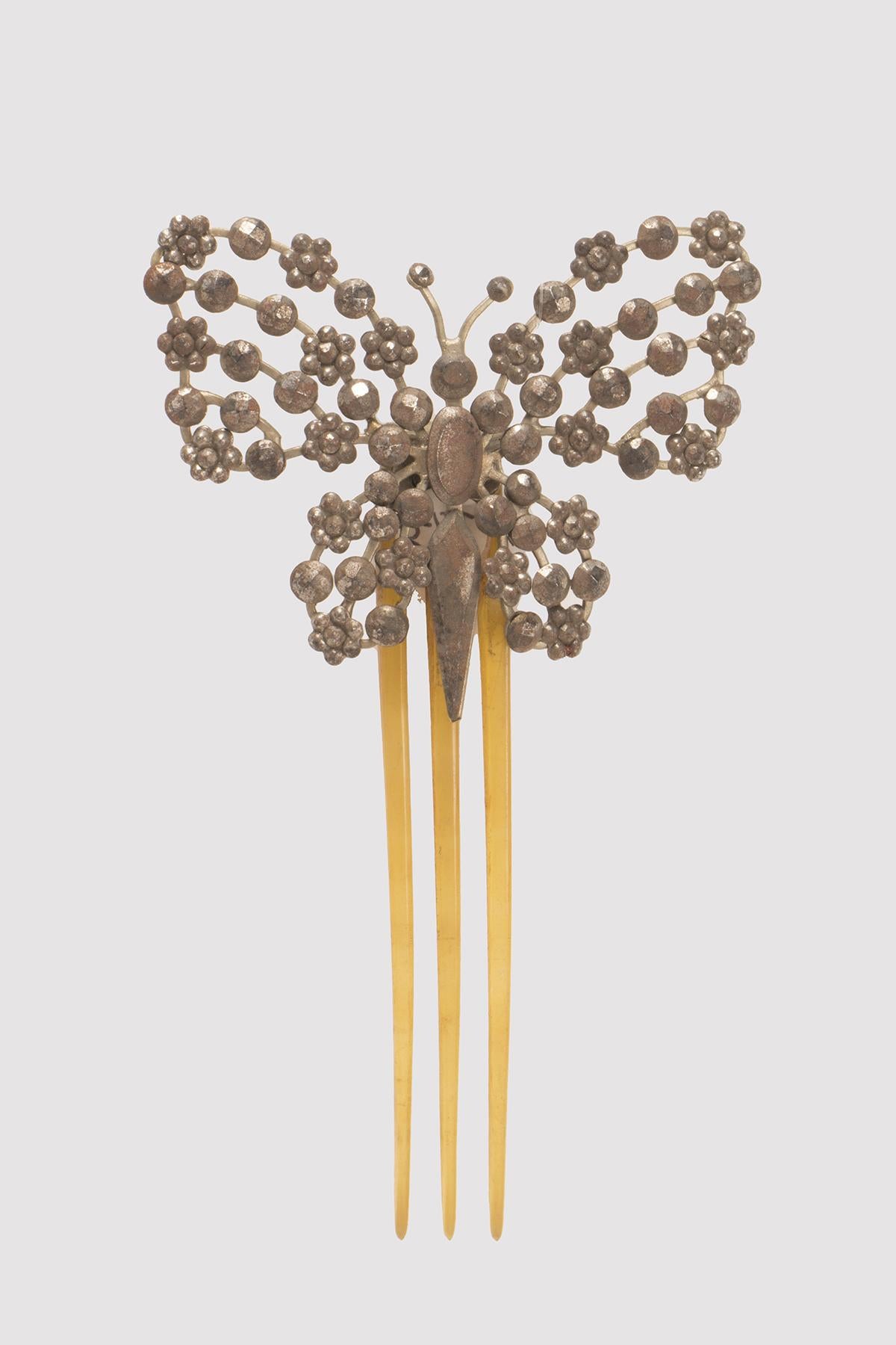 Hairdressing comb with blonde tortoiseshell prongs and cut steel decoration depicting a butterfly. France circa 1900. (SHIP TO EU ONLY)