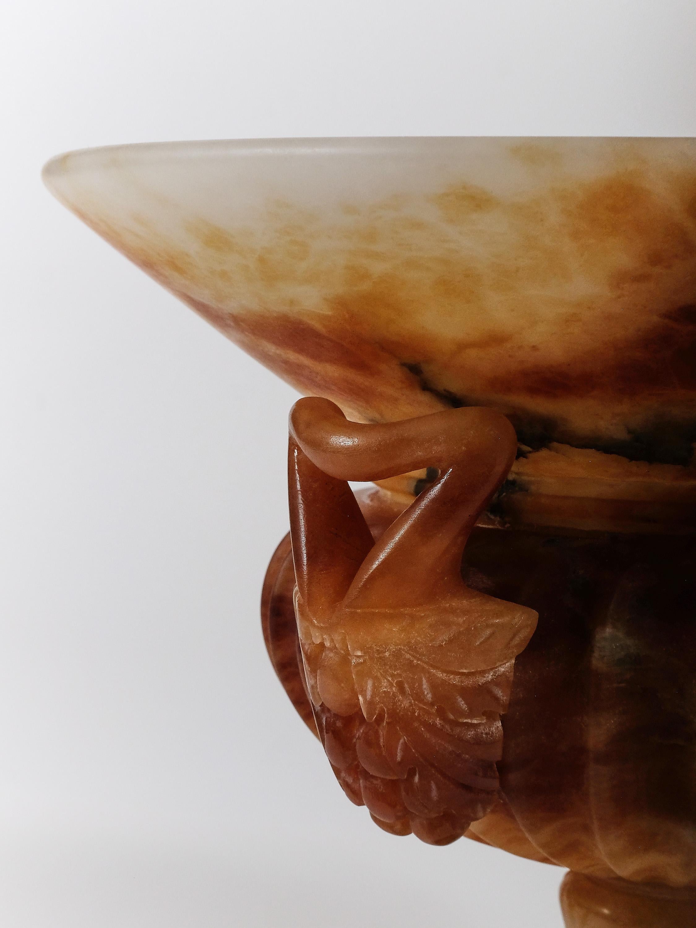 From the mountains of Tuscany comes this beautifully crafted alabaster urn, dyed in brown thus rendering the piece very translucent if placed under a light. Sober and elegant, it can house a plant, carry a candy extravaganza, or can be simply