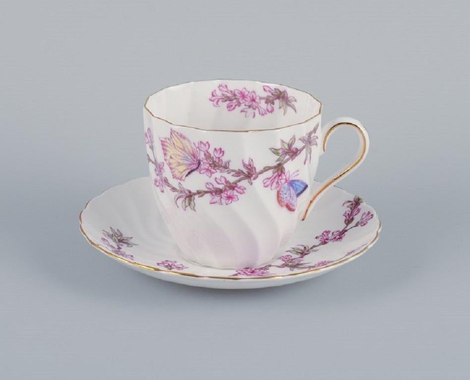 Tuscan, England, Bone China. Four sets of large coffee cups and saucers decorated with butterflies and cherry blossoms.
Mid-20th Century.
In perfect condition.
Marked.
Cup: D 9.0 x H 8.5 cm.