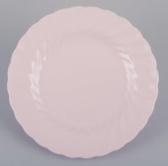 Tuscan, England. Seven plates in light pink porcelain with a wavy edge.