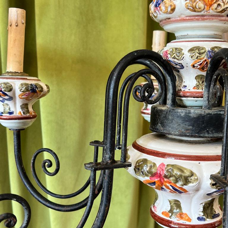 A stunning Italian hand-painted hard-wired ceramic and iron 6-arm chandelier. This piece was sourced from the estate of a Kansas oilman. We assume this piece was imported directly from Italy judging by the rest of the home! The top of the chandelier