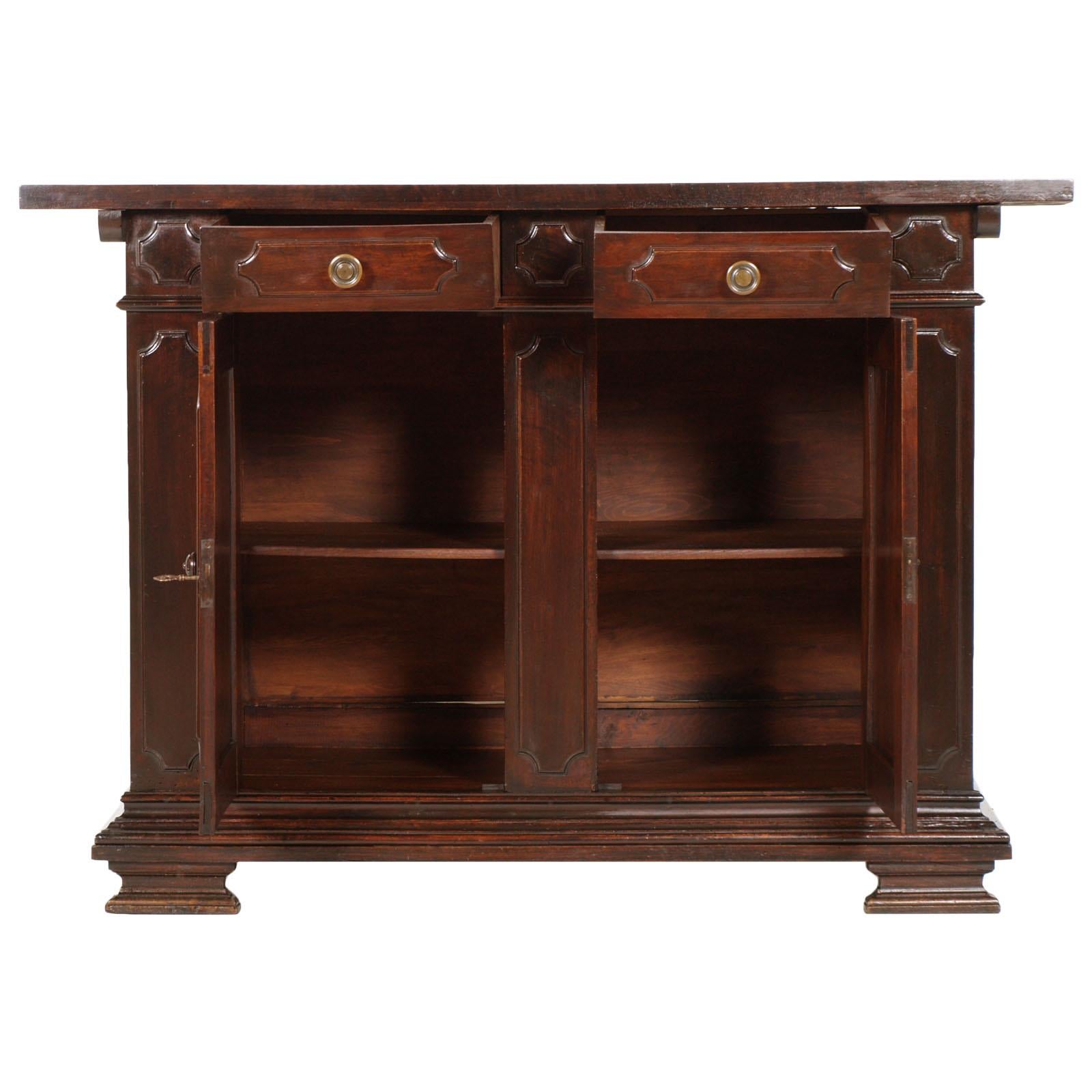 Precious early 20th century Tuscan Renaissance cabinet, cupboard, in carved solid walnut, restored and wax polished. All solid wood.
Upper drawer handles in burnished bronze, handles of the two lower doors in finely carved walnut

Measures cm: H