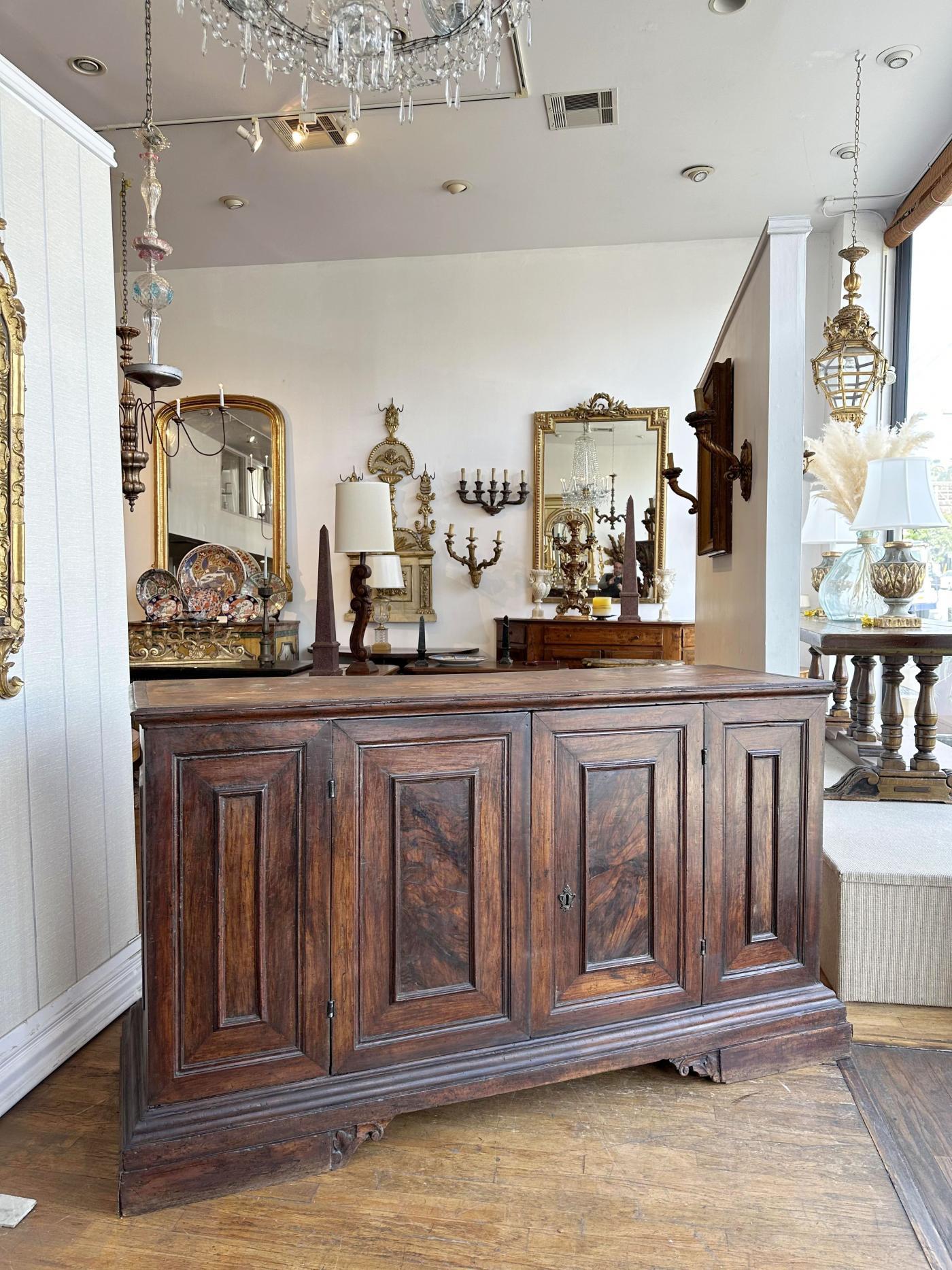 Rectangular top with molded edge over a pair of paneled doors raised on molded base with bracket feet.