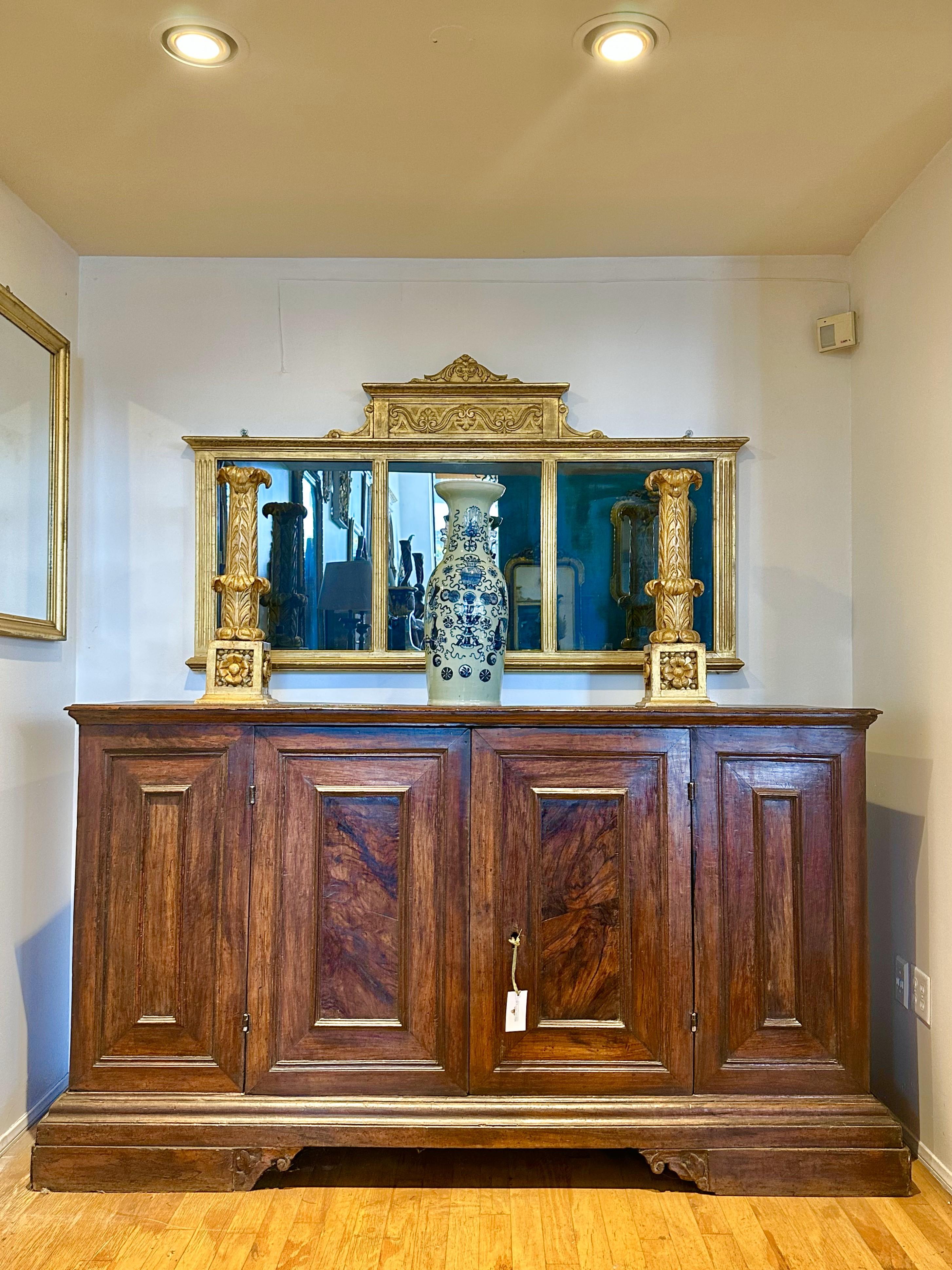 Rectangular top with molded edge over a pair of paneled doors raised on molded base with bracket feet.