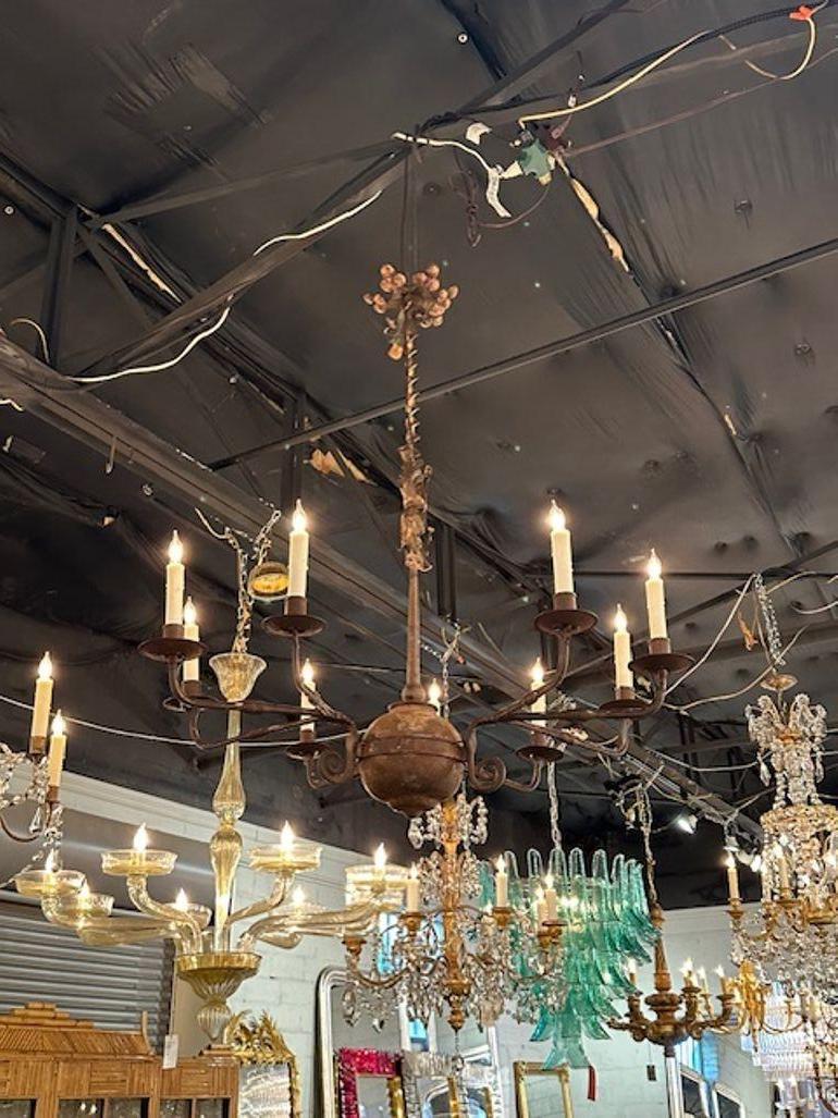 Very early 18th possibly 17th century Tuscan wood and iron 9-light chandelier. Circa 1800. The chandelier has been professionally rewired, comes with matching chain and canopy. It is ready to hang!