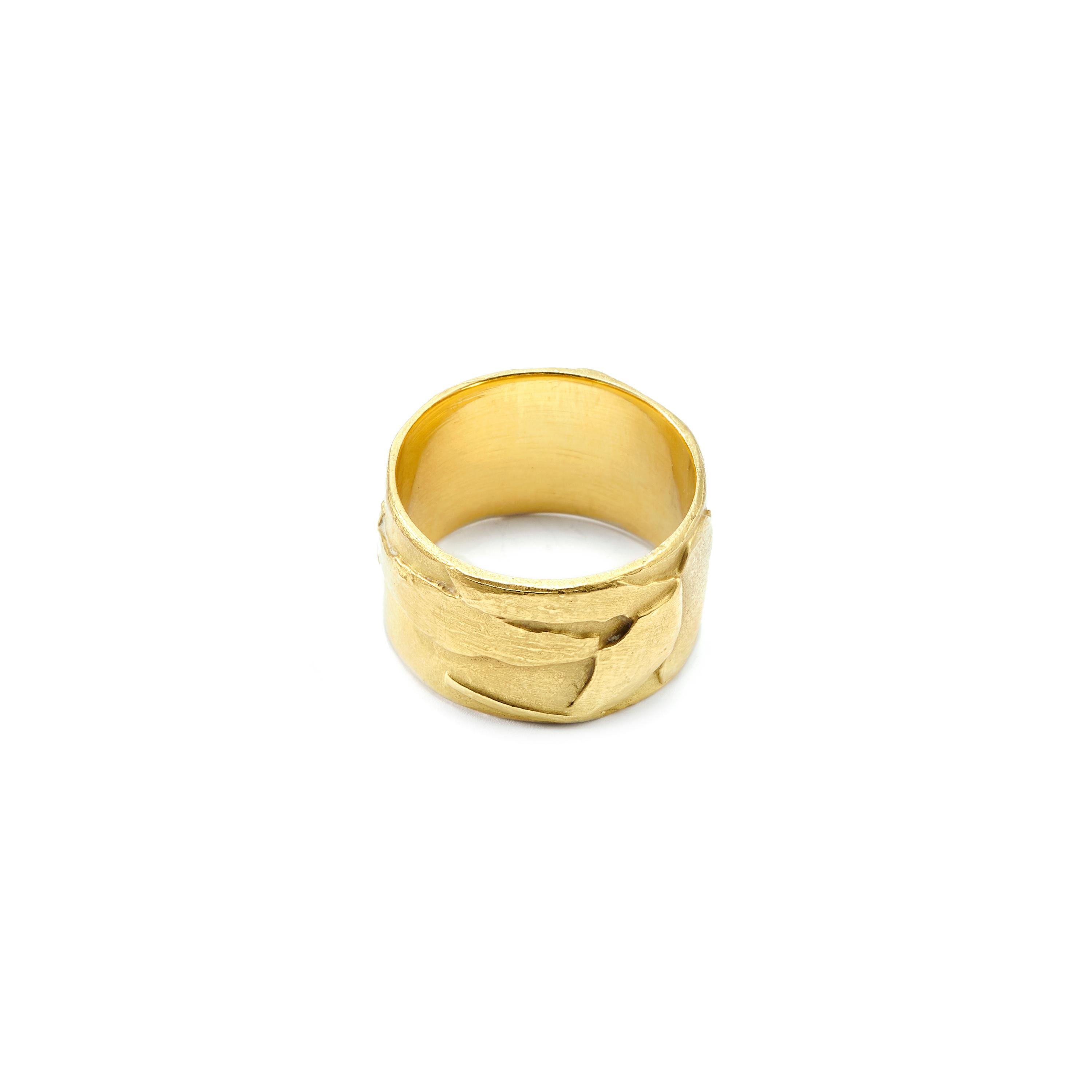 This unique 18 Karat Gold Wide Band Ring was designed by Susan Lister Locke. She was inspired by the flora and fauna of Tuscany while taking a class in the region. A lovely addition to any collection as well as a modern alternative to a wedding or