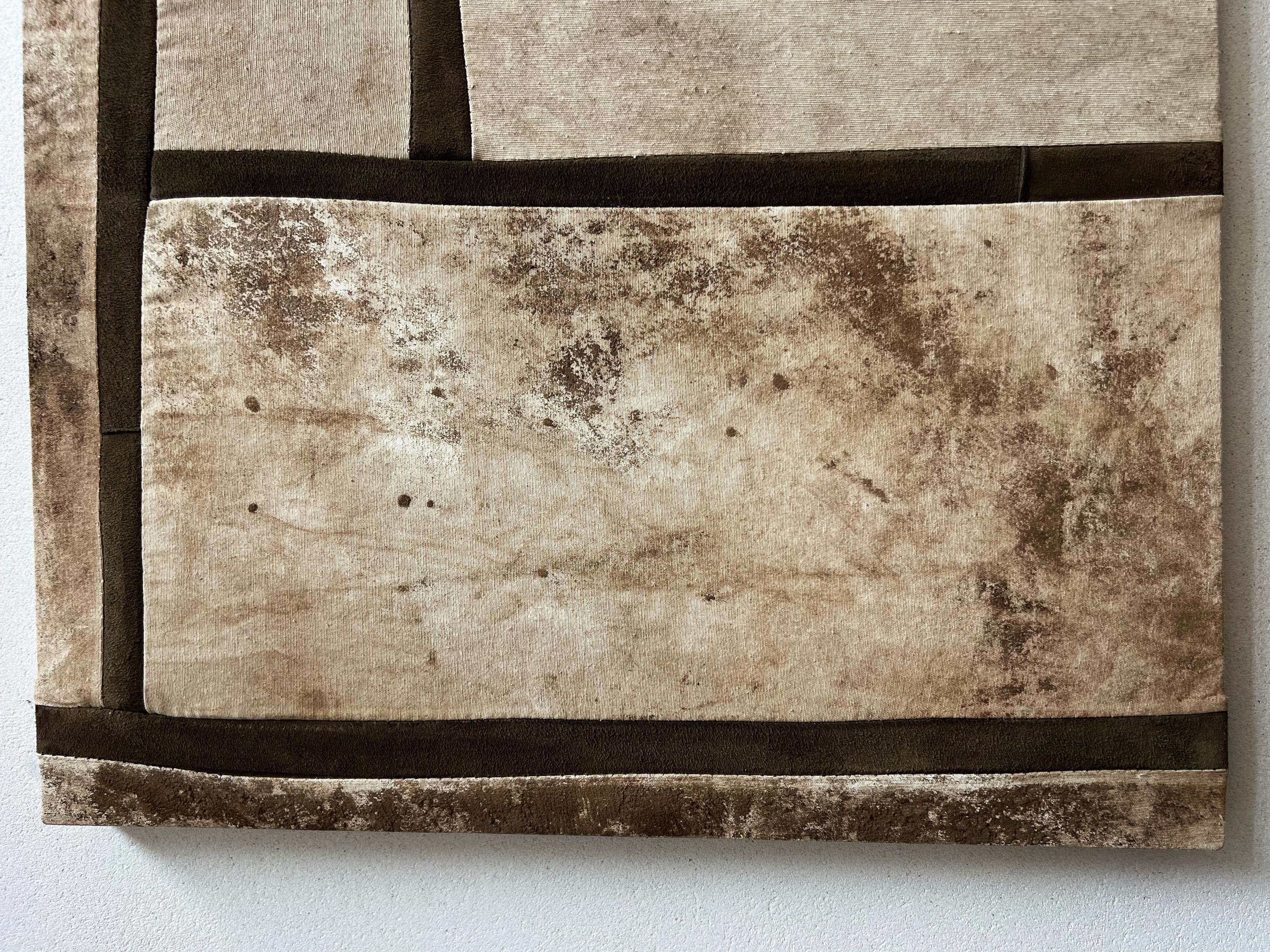 TUSET (1997, A Coruña) buries. He presents his latest series using patchwork, with paintings that have spent a year underground and leather. What emerges is an eroded map, a surface fragmented by time and weather. His works don't represent, they