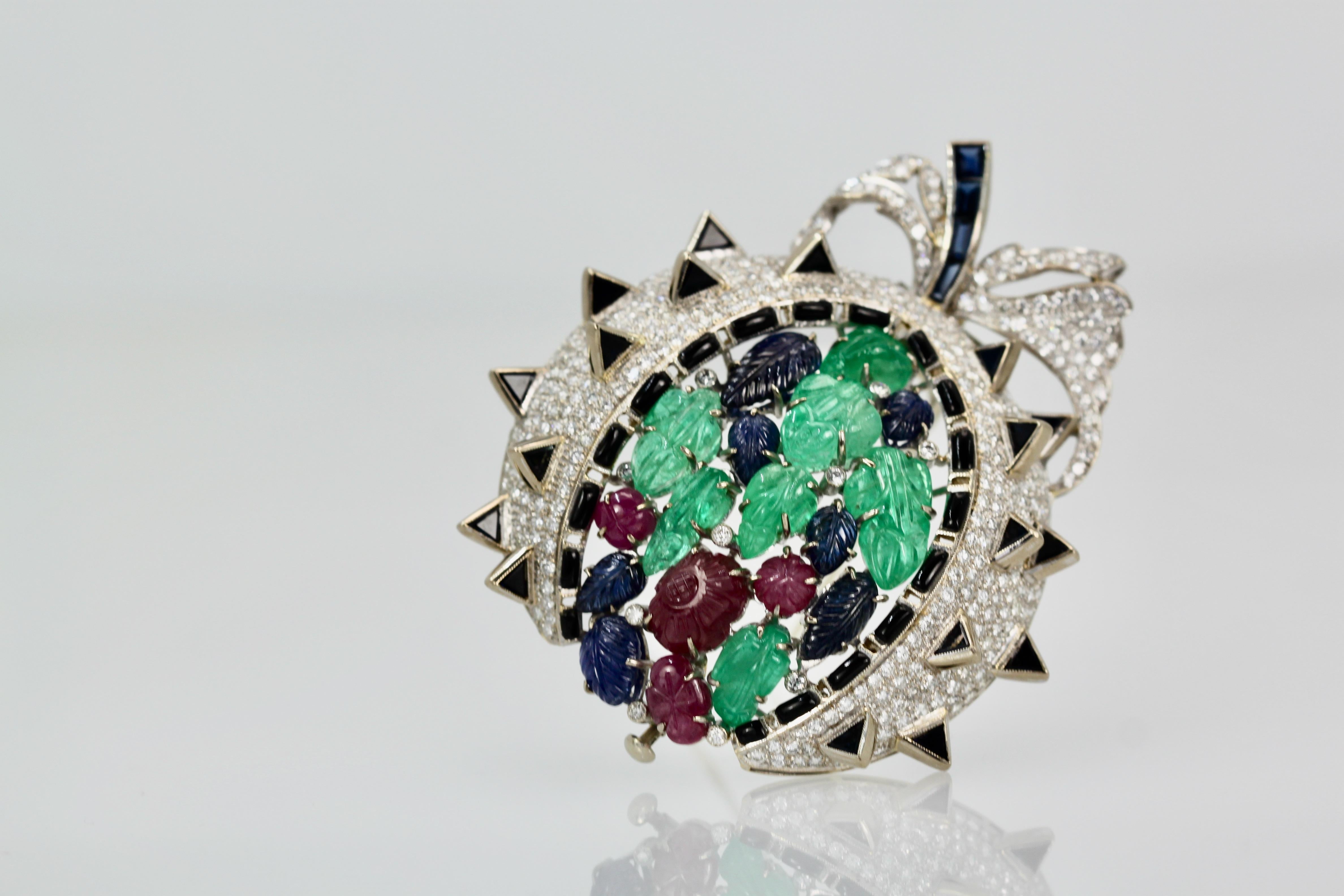 This gorgeous brooch is open like a melon and the seeds are all carved leaves and the Diamonds are the berries.  This brooch is large 6.0cm long by 5.5cm wide and weighs a whopping 48.5 grams.  There are 18 carved leaves, 7 Emeralds, 7 Sapphires, 4