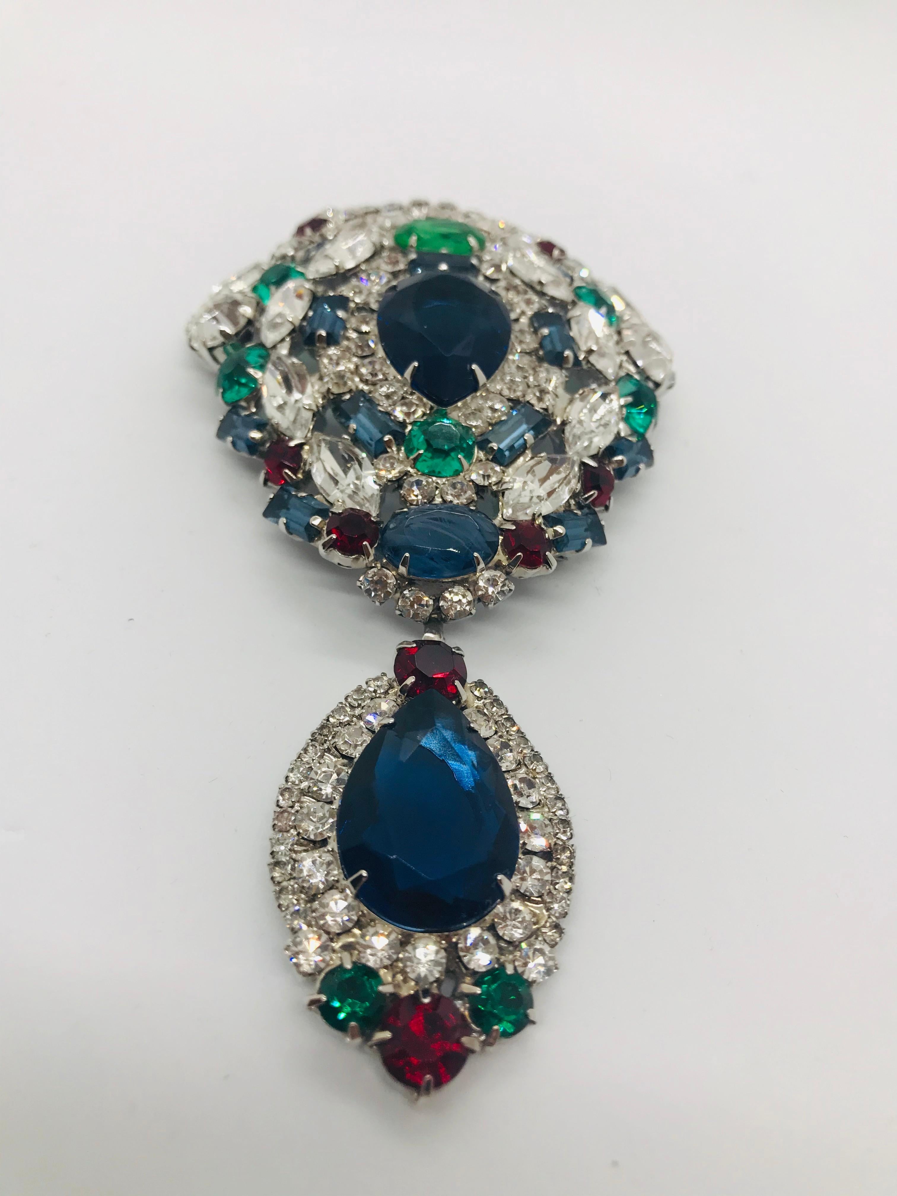 A tutti frutti brooch with a hanging pear shaped drop in clear ruby, emerald and sapphire Austrian crystal.  Created using rare vintage Austrian crystal stones from the 1950s and 1960s. It has a distinct 