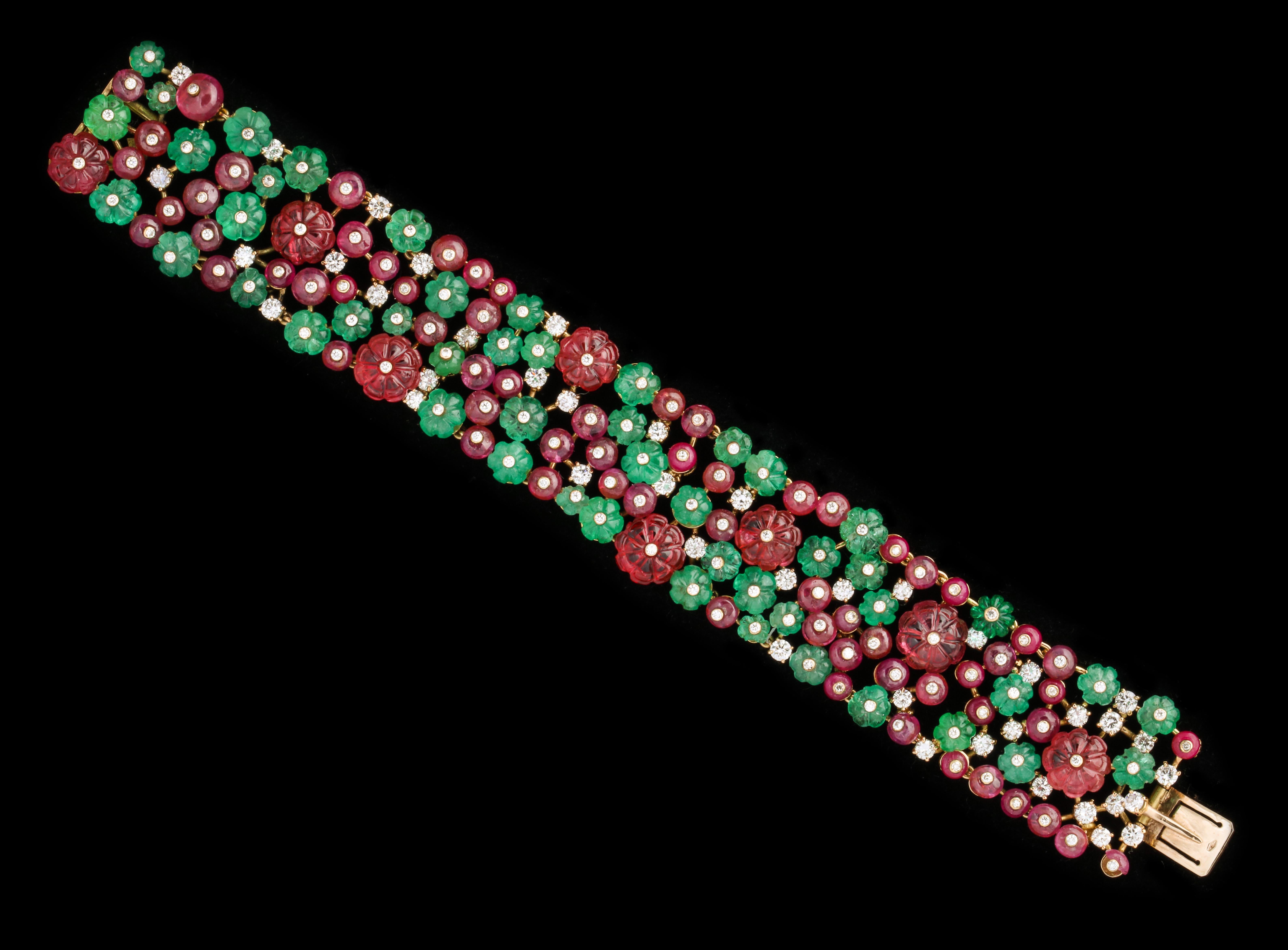 Bulgari bracelet with carved emeralds rubies and spinels. 

Comes with original box.