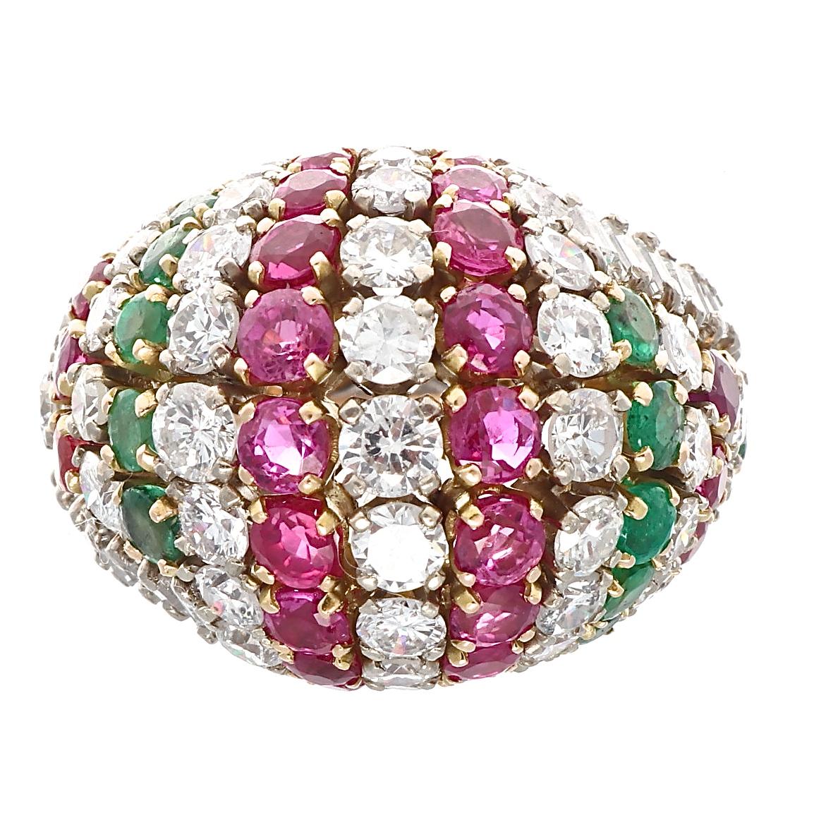 A dazzling display of color that lights up any room. Designed in alternating rows of diamonds, rubies and emeralds. Crafted in 18k yellow gold. Ring size 5 3/4 and may be re-sized to fit. 