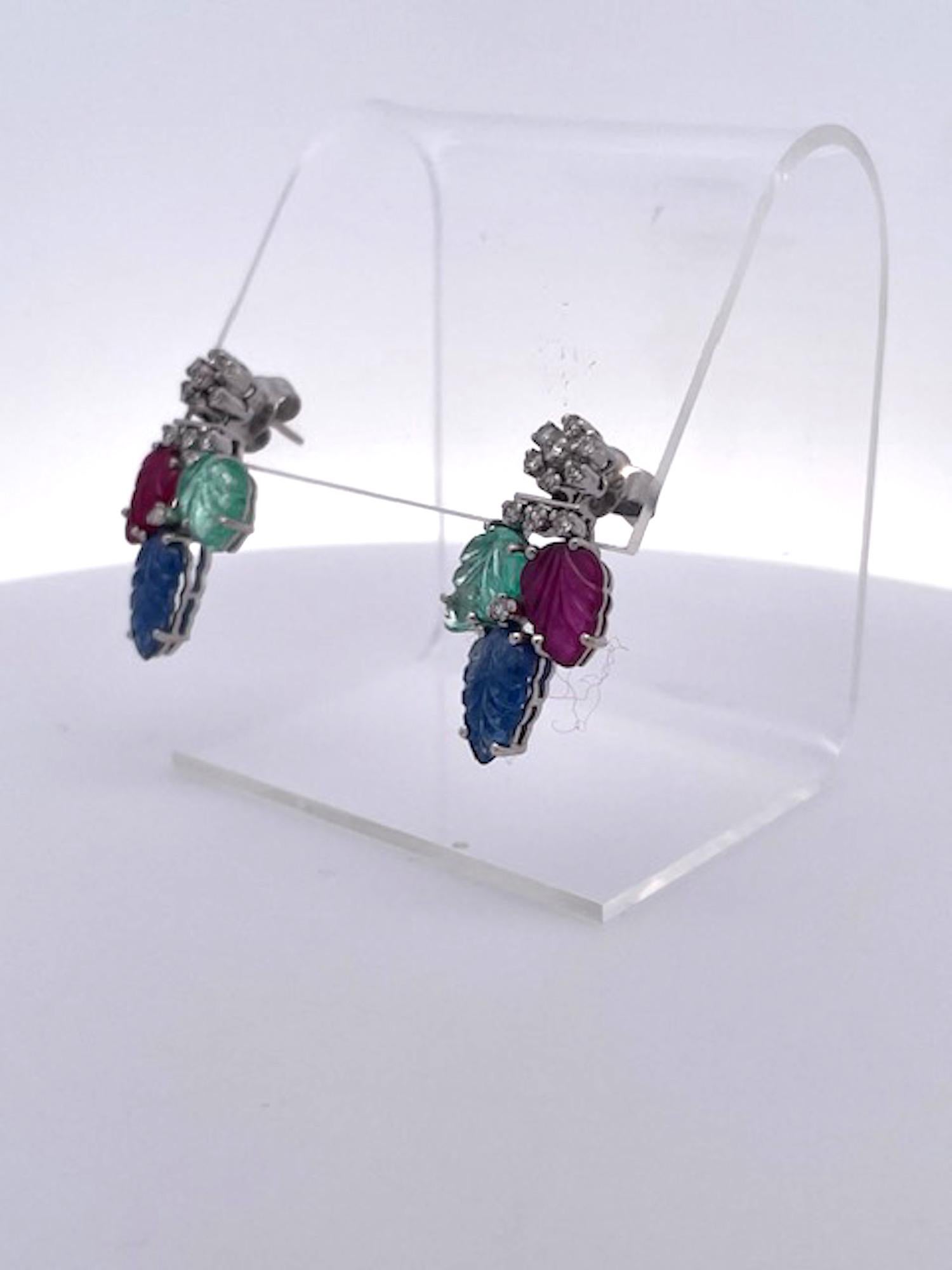 These Tutti Frutti Earrings come out of eastern europe and are simple but pack a punch.  There are (1) one carved Emerald, (1) Carved Sapphire and (1) carved Ruby.  Each of these stones are carved in a leaf form and each weigh at least (1) one carat