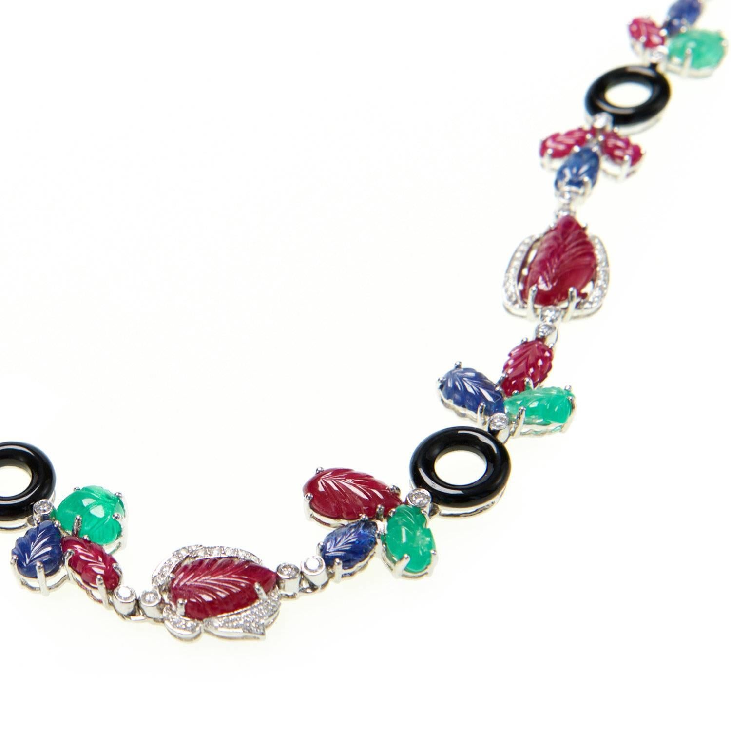 Ri Noor's Multi Gem Necklace is a striking statement piece that features an assorted collection of jewels including white diamonds, rubies, sapphires, emeralds, and onyx all set in 18k white gold. The colorful gemstones are carved and set in a