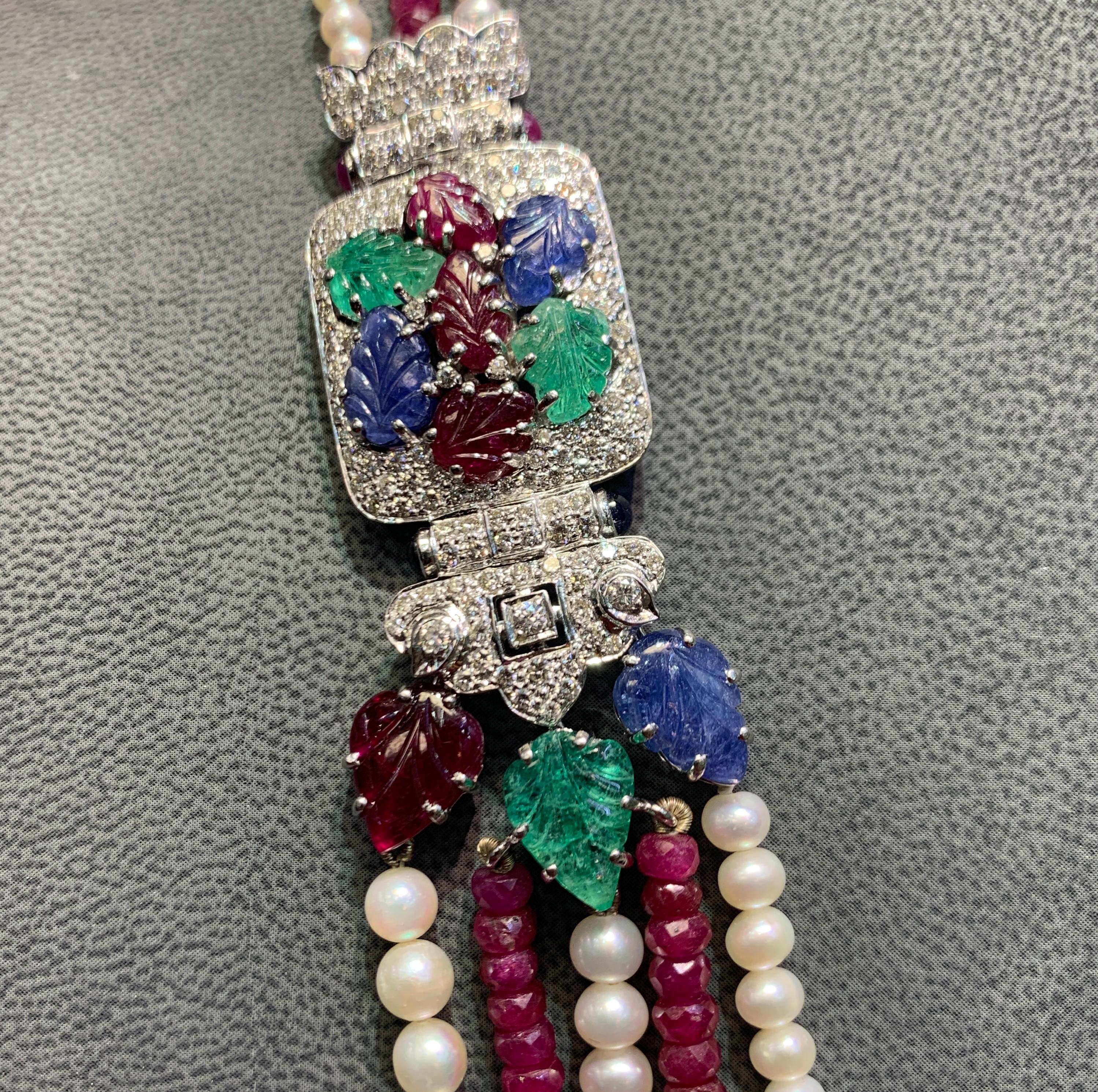 Tutti Frutti Ruby Bead and Cultured Pearl Necklace
4 Strands of ruby beads & 7 strands of pearls attached by ruby sapphire, emerald & diamonds leaf enhancers.
longest strand length: 11.75