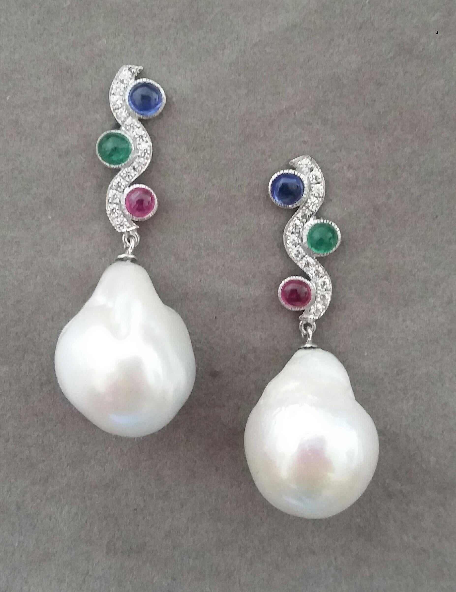 In these classic Tutti Frutti Style earrings the tops are 2 White Gold and Diamonds  wavy bars, 26 round full cut diamonds weighing 0,26 carats,and 3 pairs Rubies ,Emeralds and Blue Sapphires round cabs 4 mm in diameter,in the lower parts we have 2