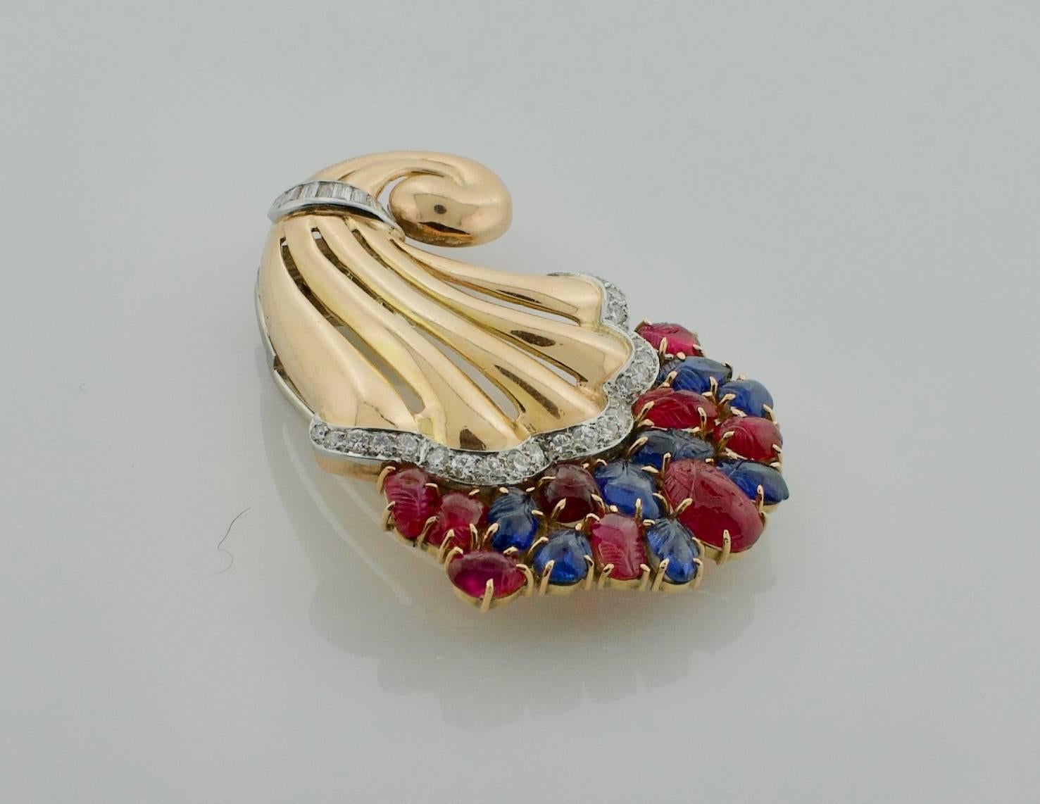 ‘Tutti Frutti’ Style 1950's Carved Ruby, Sapphire and Diamond Brooch 
Purchased From a famous Hollywood Family Under The Condition That we Protect Their Anonymity 
Seventeen Carved Rubies and Sapphires weighing 8.00 carats approximately [bright and