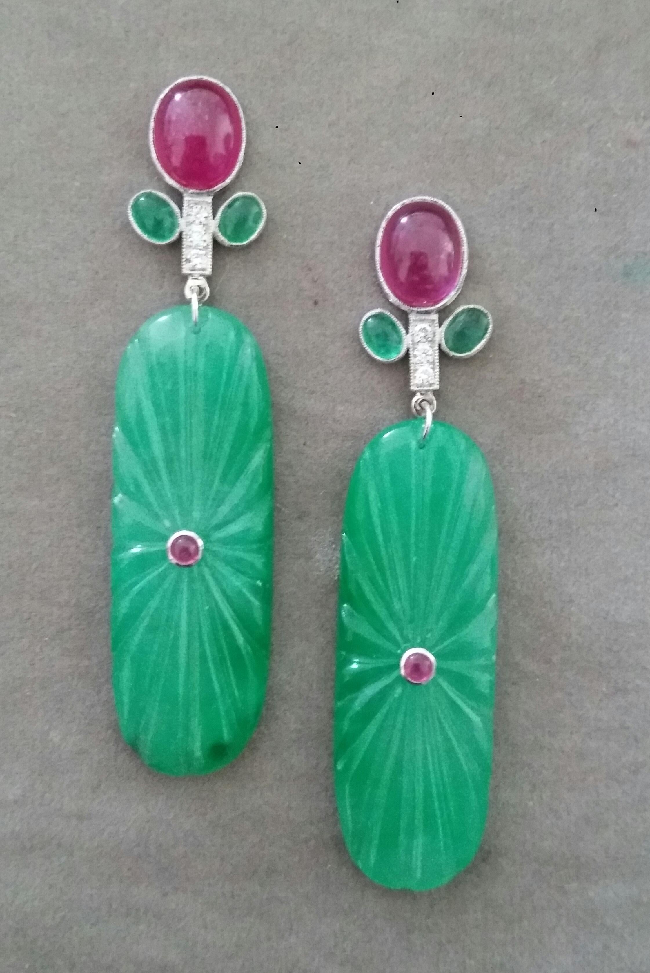 In these classic Tutti Frutti Style earrings the tops are 2 White Gold Branches, 6 round full cut diamonds weighing 0,18 carats,and 2 pairs of  oval Emerald cabs measuring 5x7 mm. and 1 pair of oval Ruby cab measuring 8x10 mm ,in the lower parts we