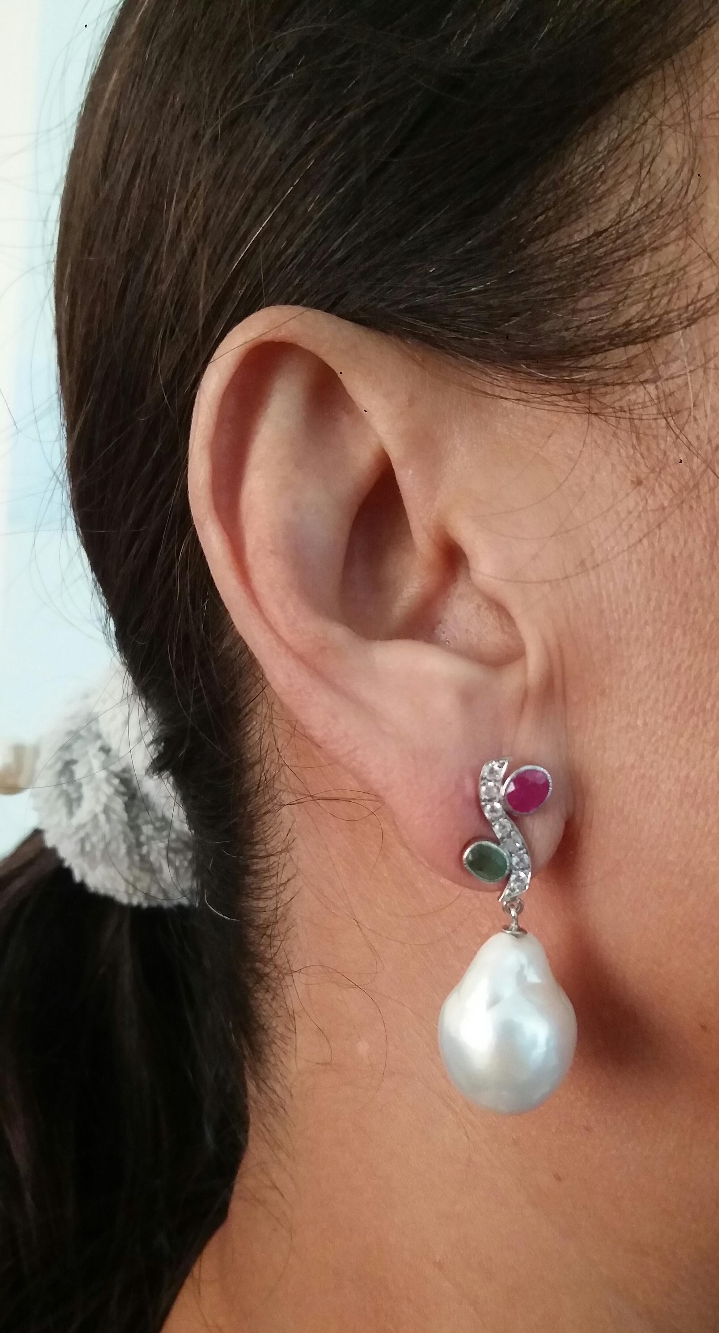 In these classic Tutti Frutti Style earrings the tops are 2 White Gold and Diamonds  Branches, 14 round full cut diamonds weighing 0,14 carats,and 3 pairs of faceted 4x5 mm. Rubies ,Emeralds,in the lower parts we have 2 high luster White Baroque