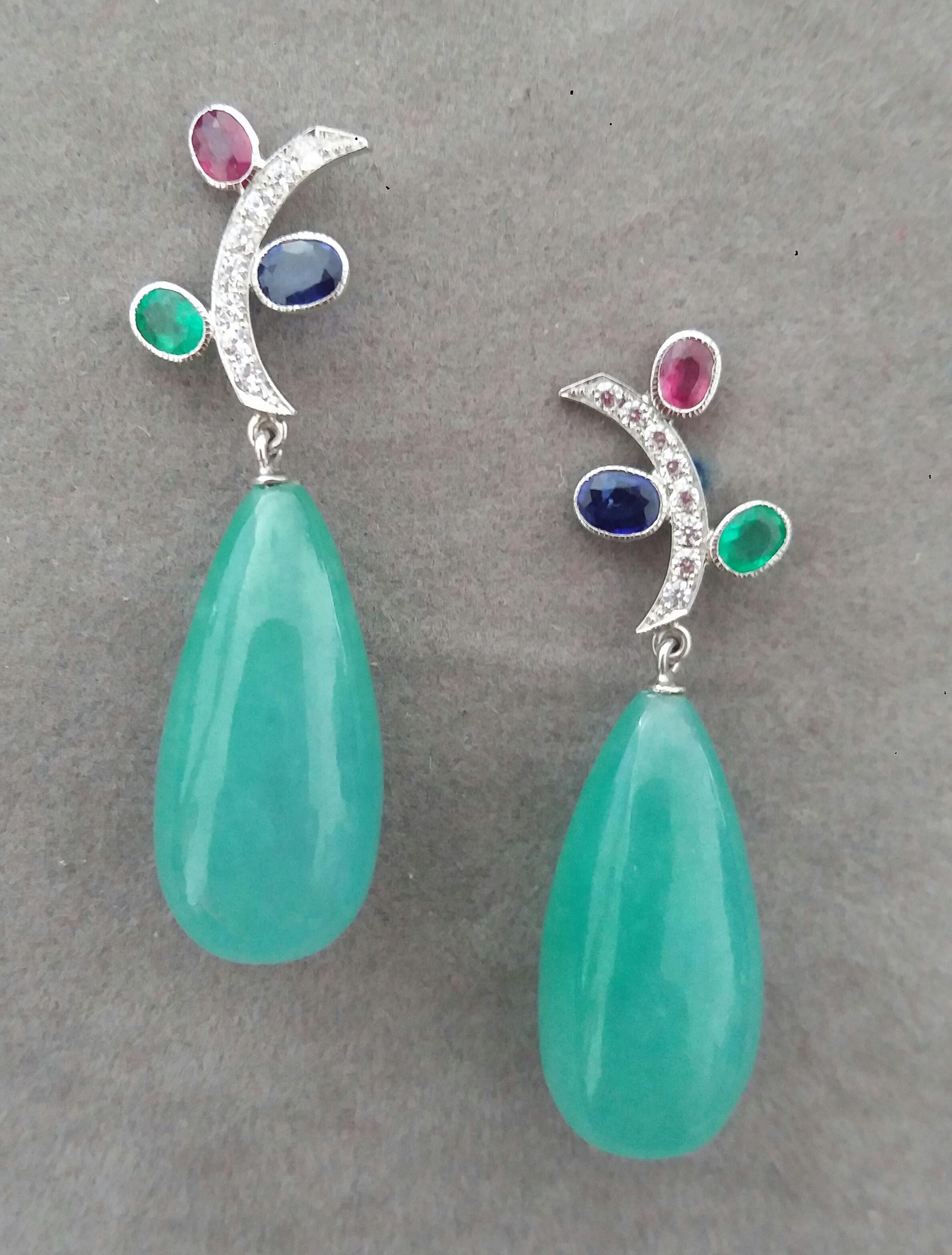 In these classic Tutti Frutti Style earrings the tops are 2 White Gold and Diamonds  Branches, 16 round full cut diamonds weighing 0,25 carats,and 3 pairs of faceted 4x5 mm. Rubies ,Emeralds and Blue Sapphires ,in the lower parts we have 2 Jade