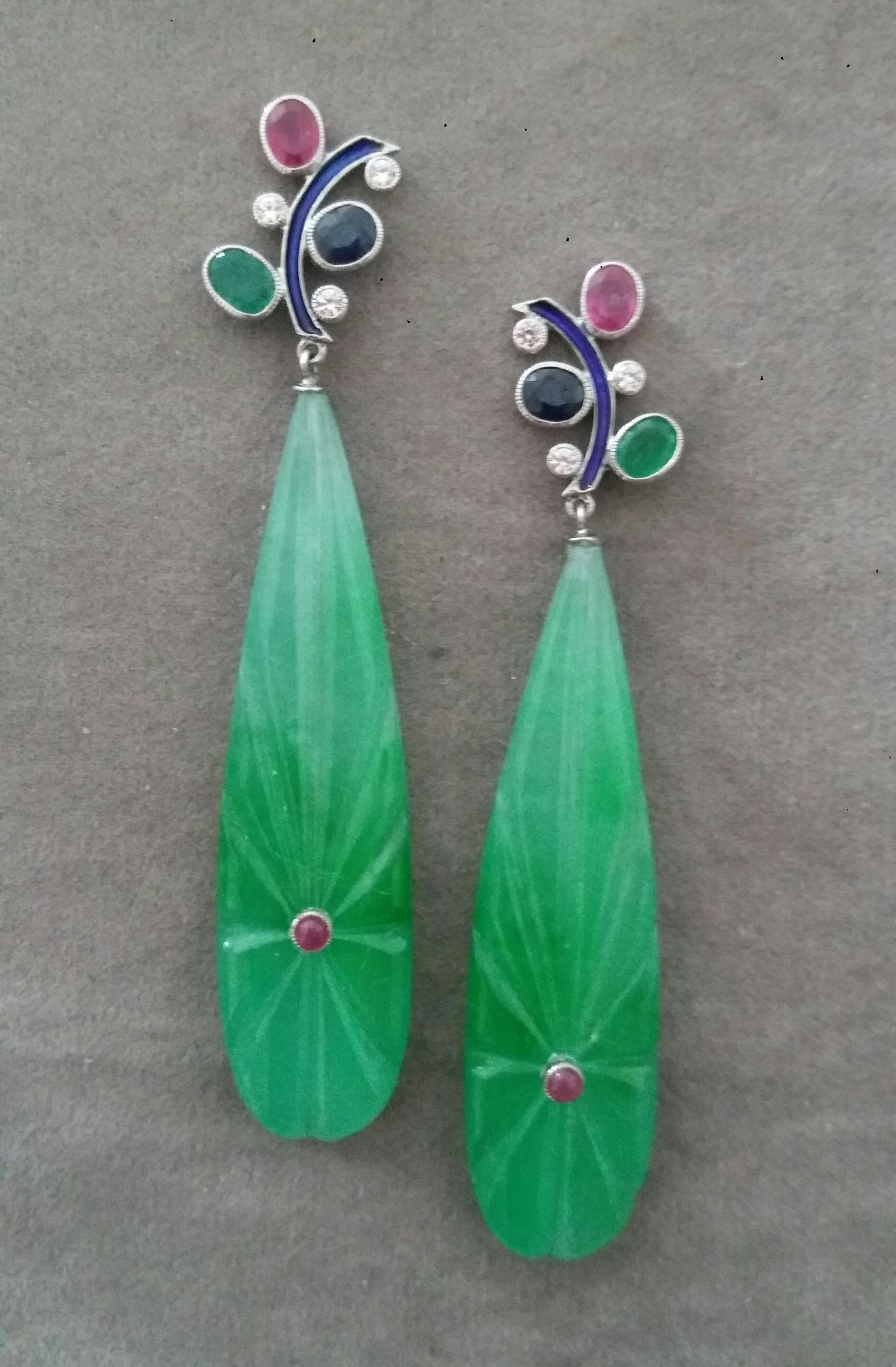 In these classic Tutti Frutti Style earrings the tops are 2 White Gold, Diamonds and Blue Enamel Branches, 6 full brilliant cut diamonds ,and 3 pairs of faceted 4x5 mm. Rubies ,Emeralds and Blue Sapphires ,in the lower parts we have 2 Engraved Jade